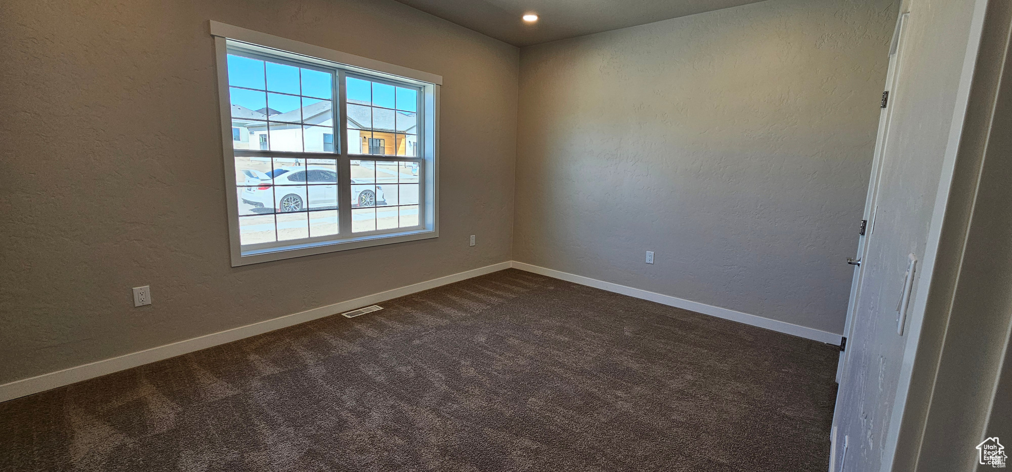 Carpeted empty room with a healthy amount of sunlight