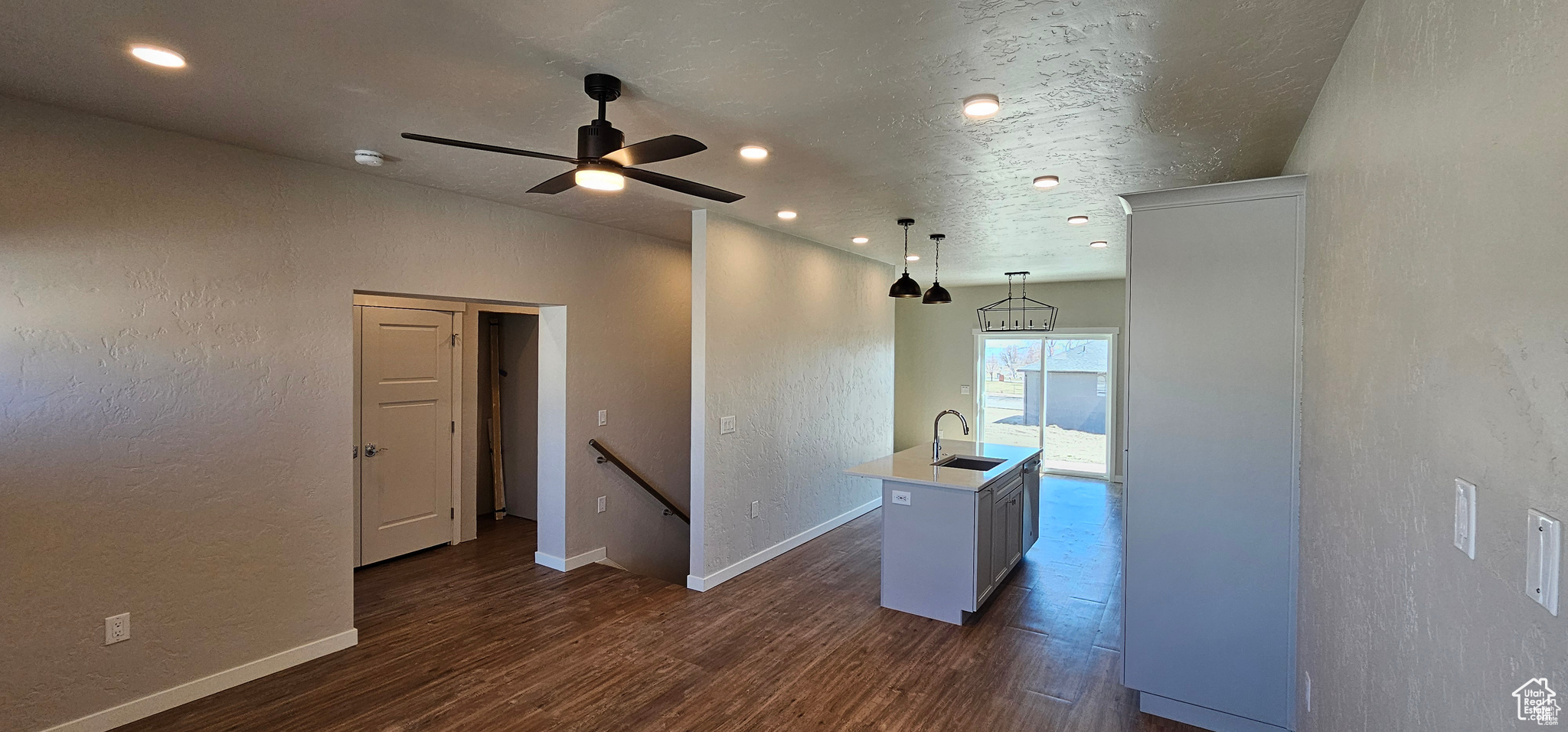 Unfurnished room with sink, ceiling fan, and dark hardwood / wood-style floors