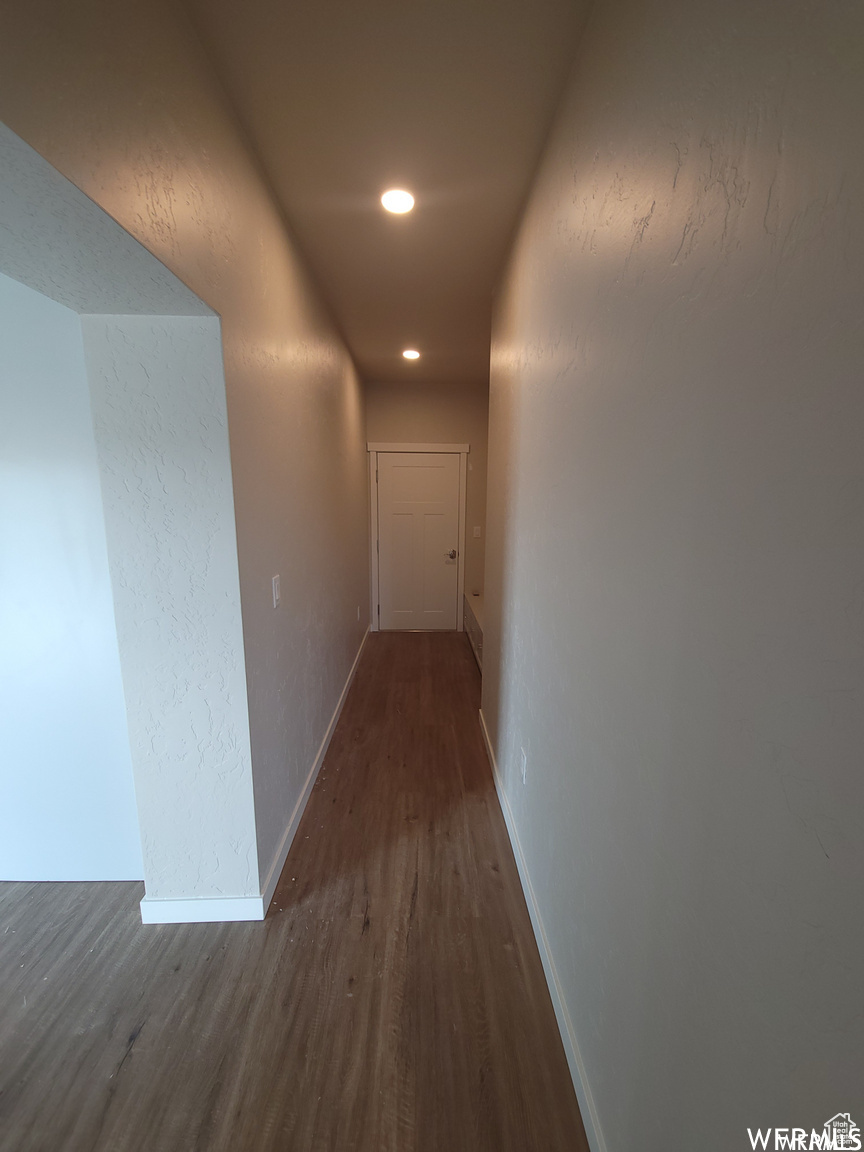 Corridor featuring dark wood-type flooring