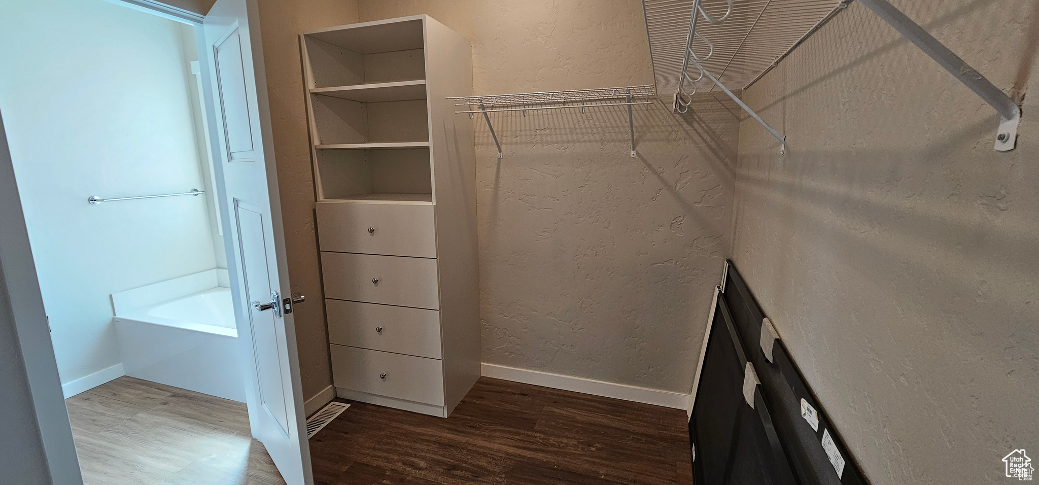 Walk in closet featuring wood-type flooring