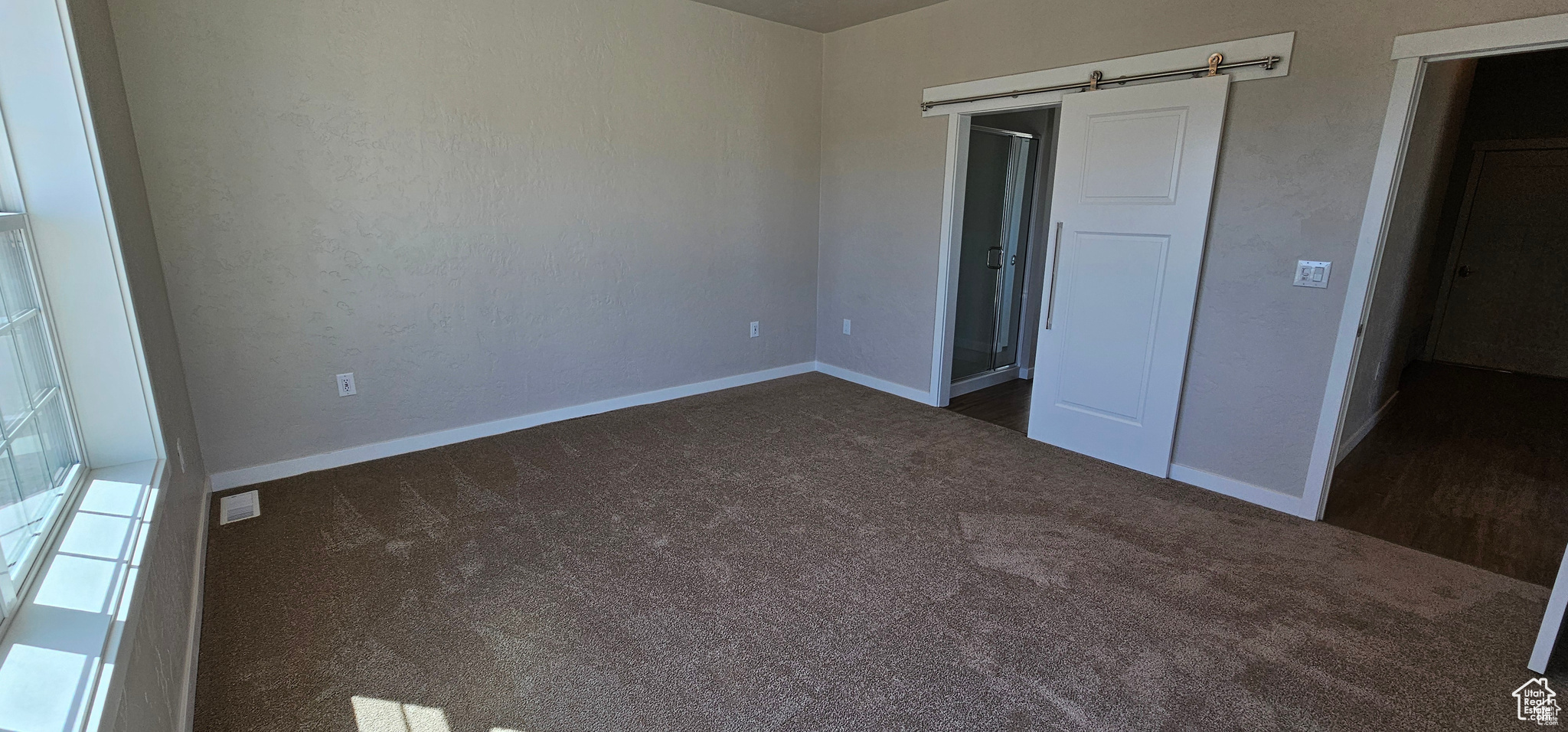 Unfurnished bedroom featuring dark colored carpet