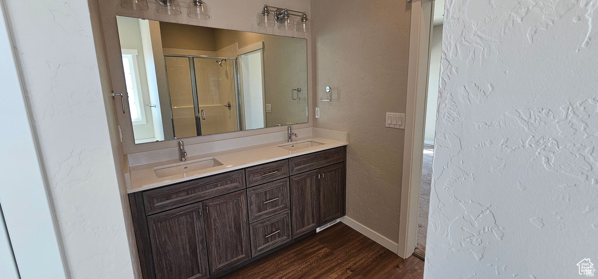 Bathroom featuring double sink vanity and hardwood / wood-style flooring