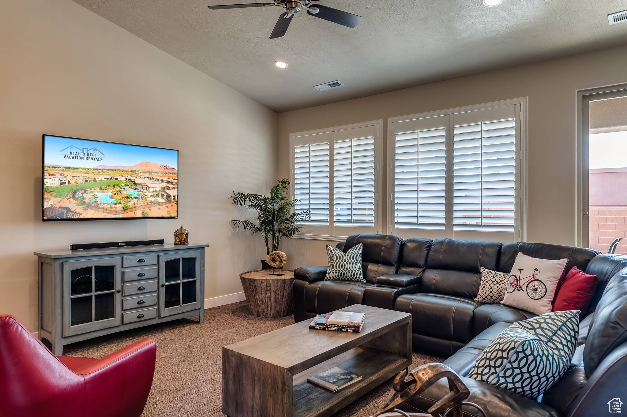 Living room featuring carpet and ceiling fan