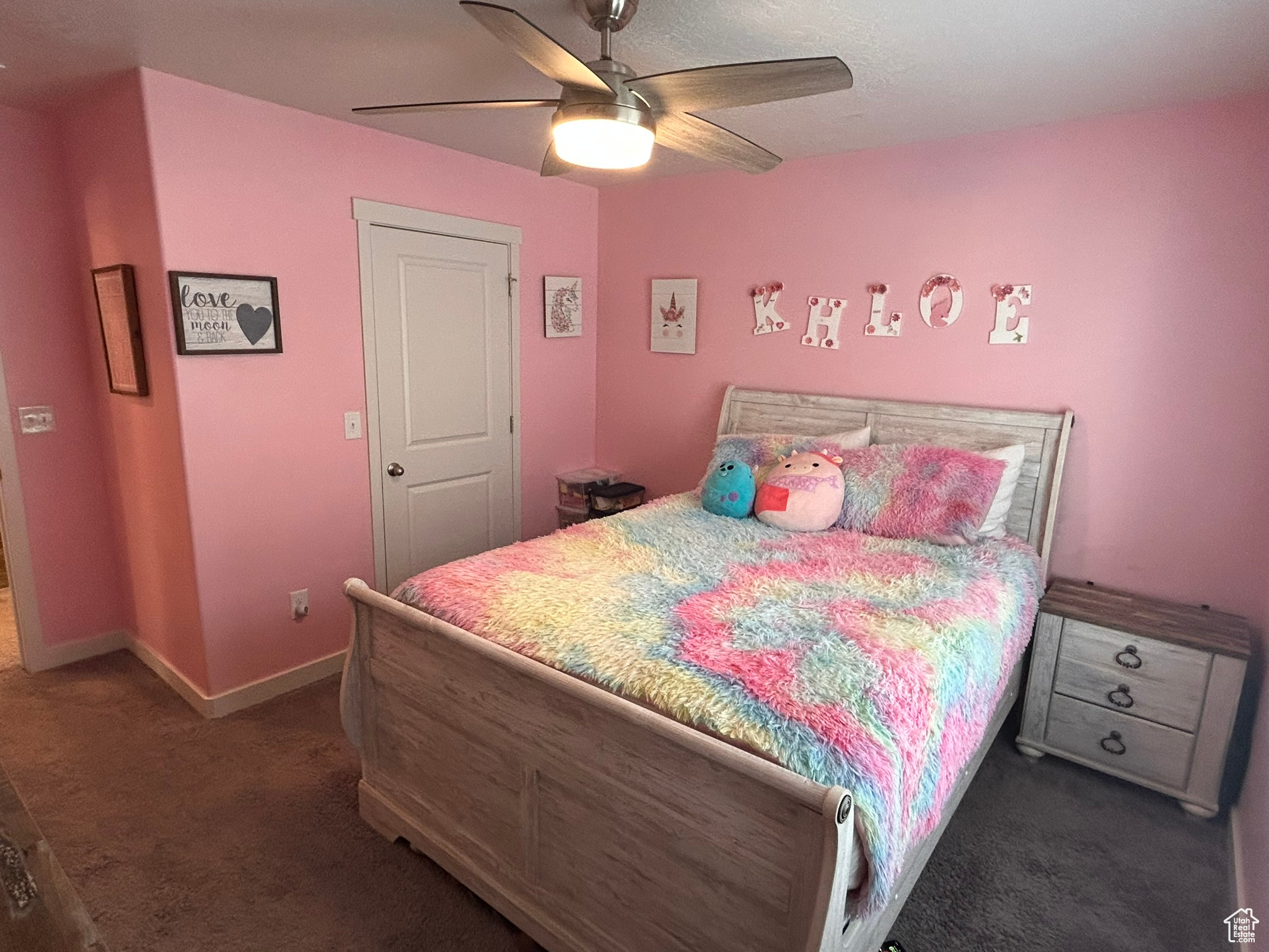 Bedroom with dark colored carpet and ceiling fan