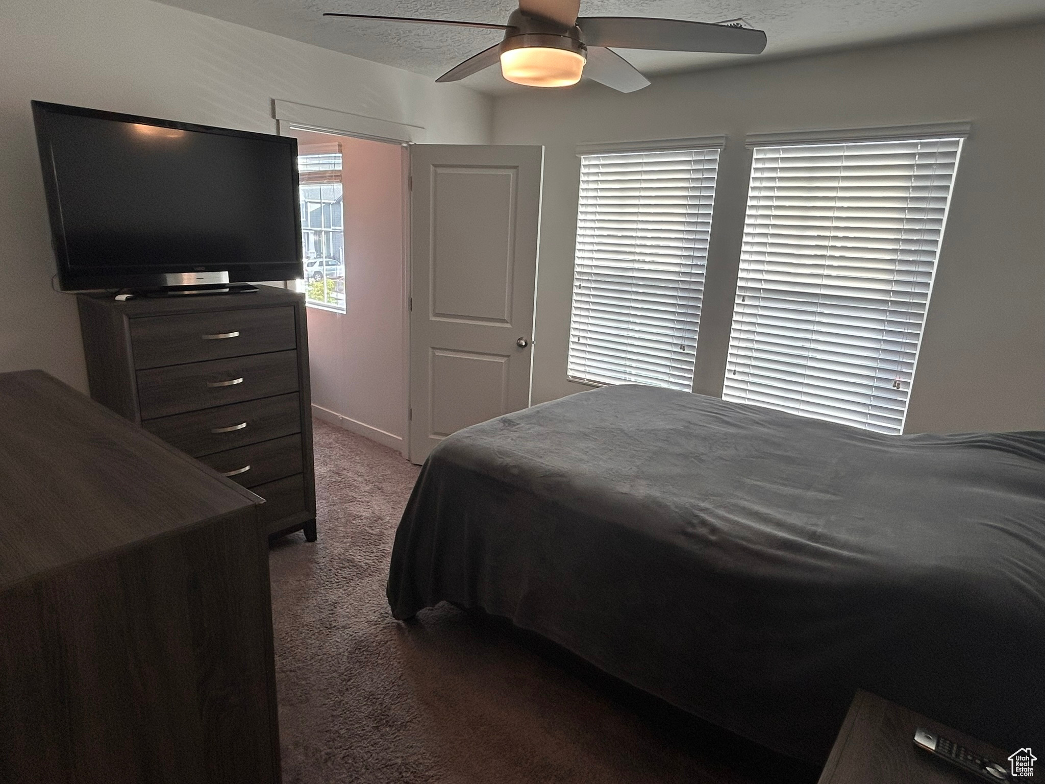 Bedroom with ceiling fan and carpet floors