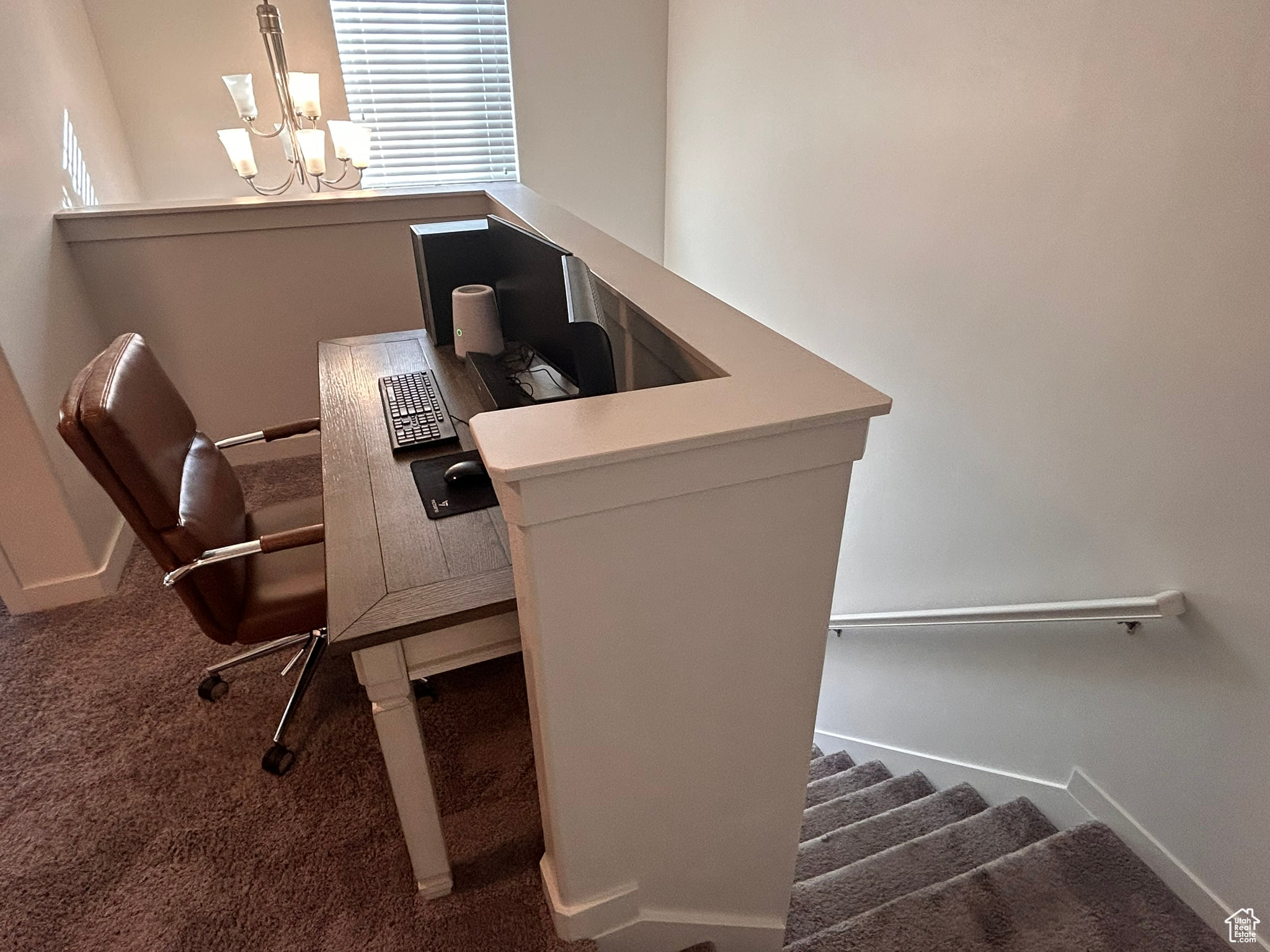 Office with a chandelier and carpet