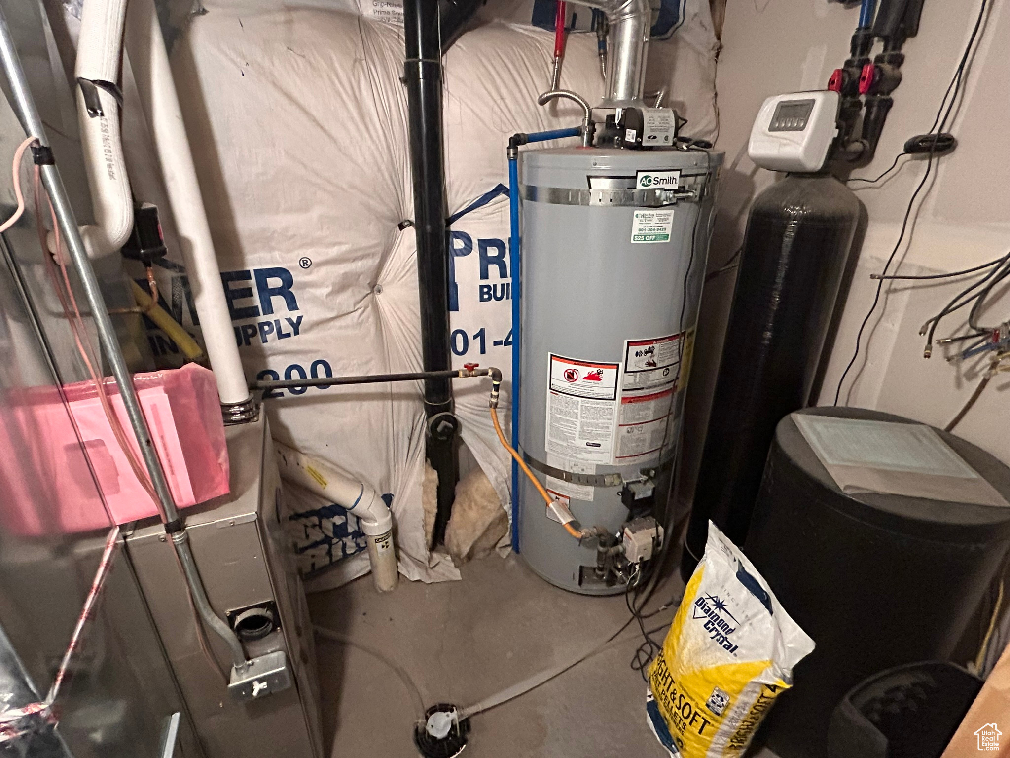 Utility room featuring secured water heater