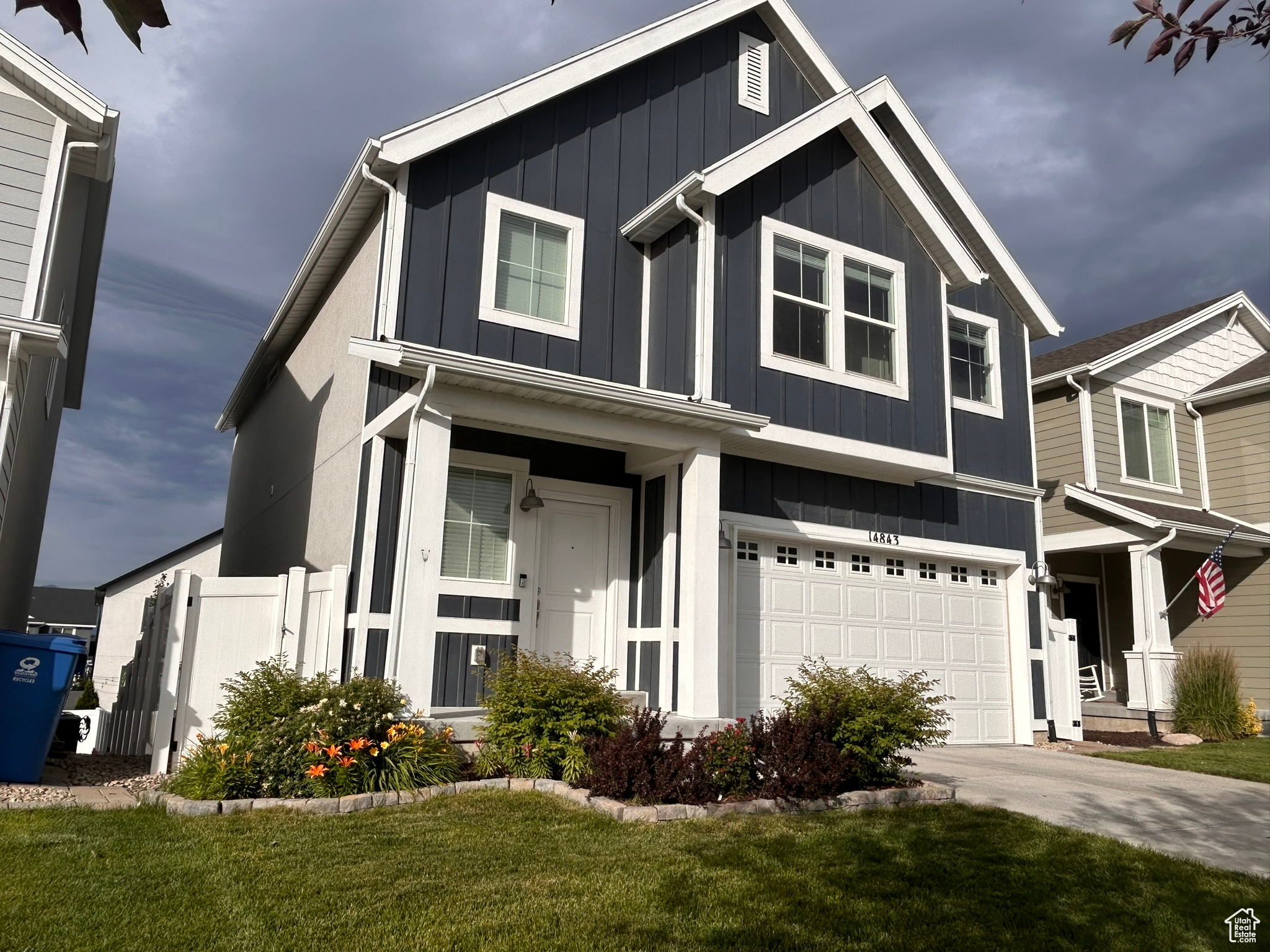 View of front of house with a front lawn and a garage