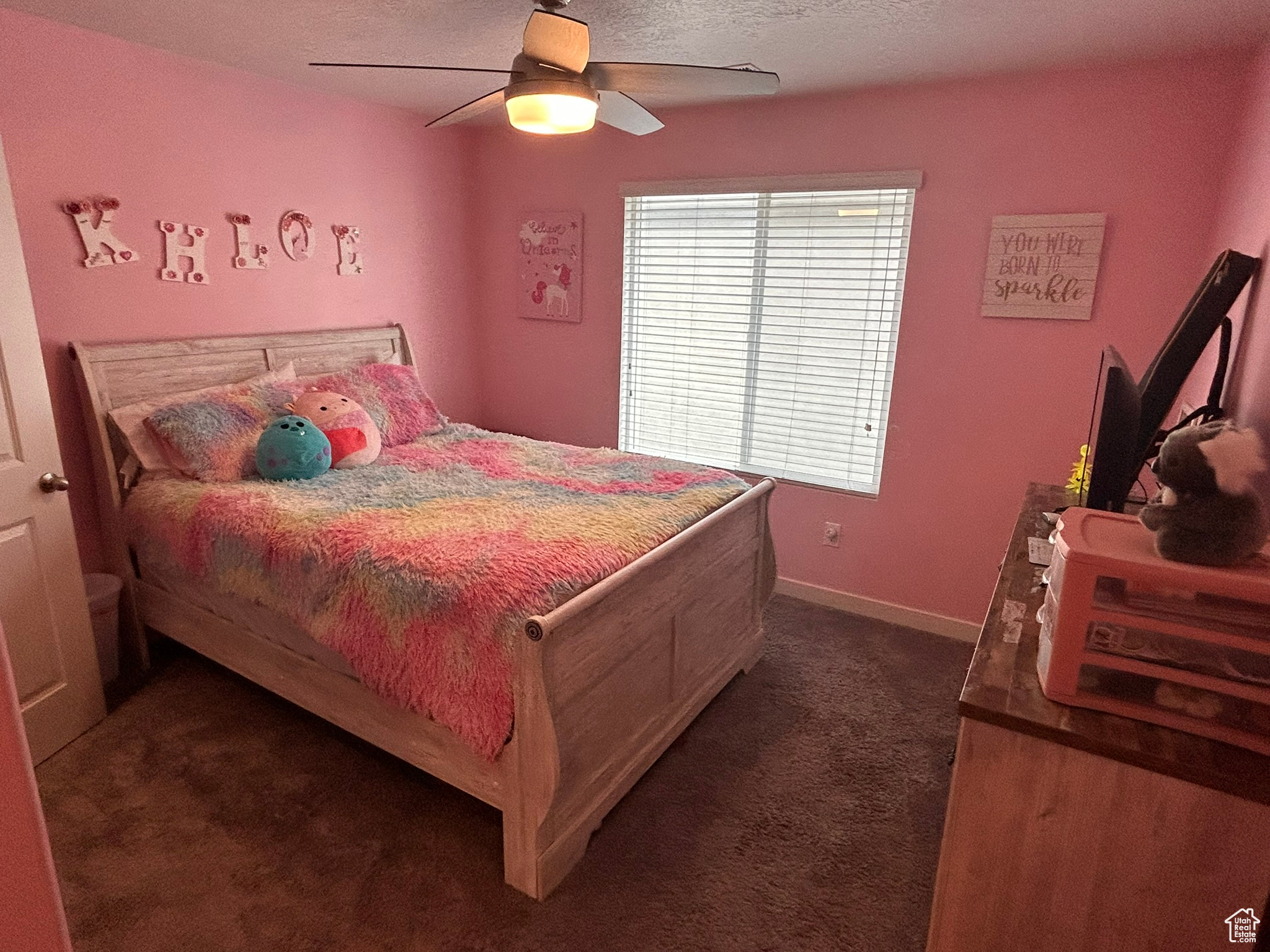 Bedroom featuring ceiling fan, a textured ceiling, and dark carpet