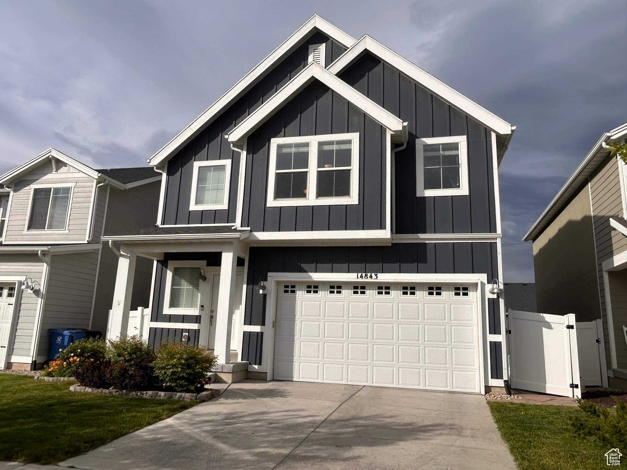 View of front of property featuring covered porch and a garage