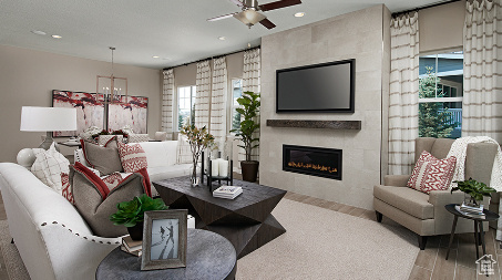Living room featuring hardwood / wood-style flooring, a fireplace, and ceiling fan