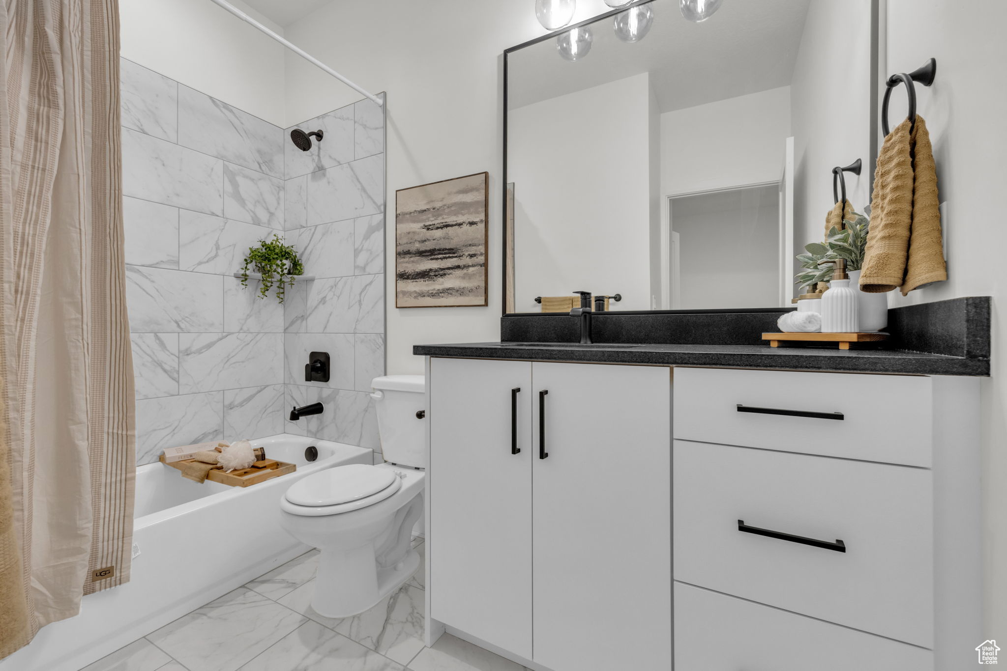 Full bathroom featuring tile flooring, vanity, toilet, and shower / tub combo