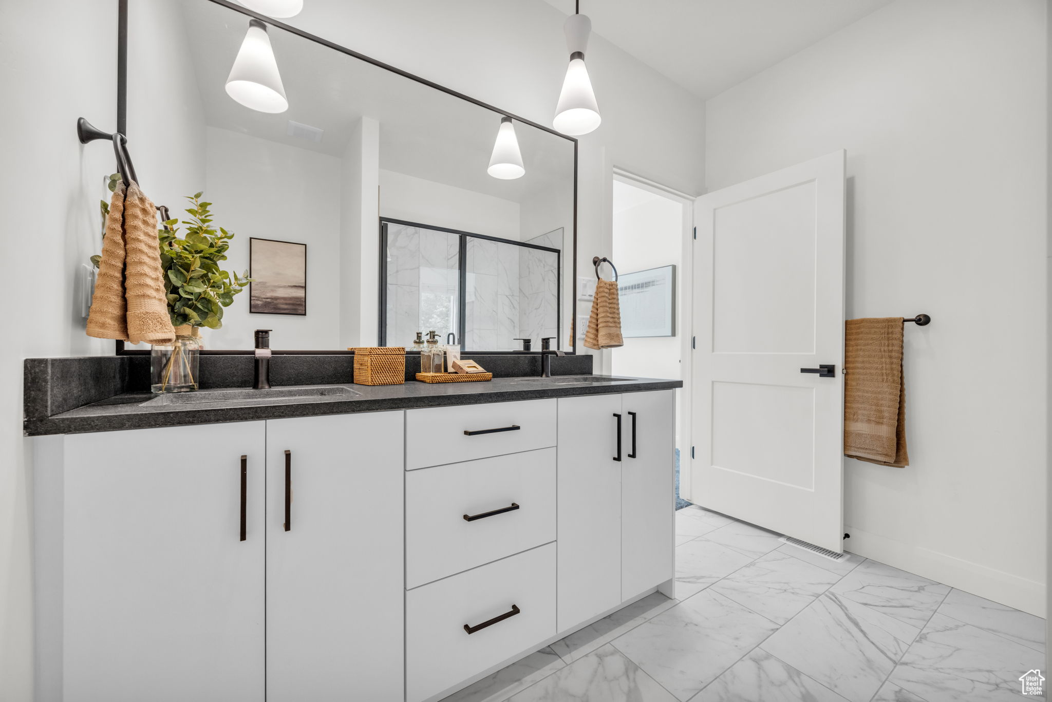 Bathroom with tile floors and double vanity