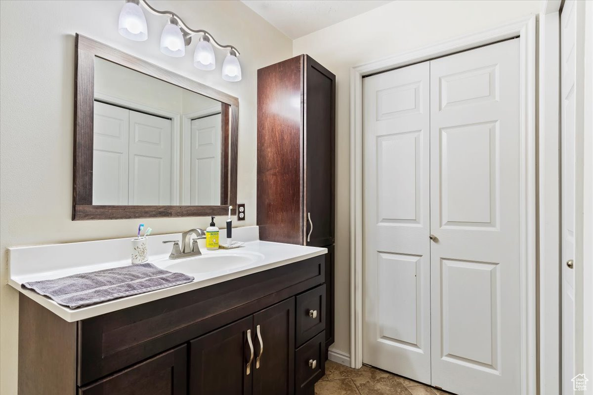 Bathroom featuring tile floors and vanity