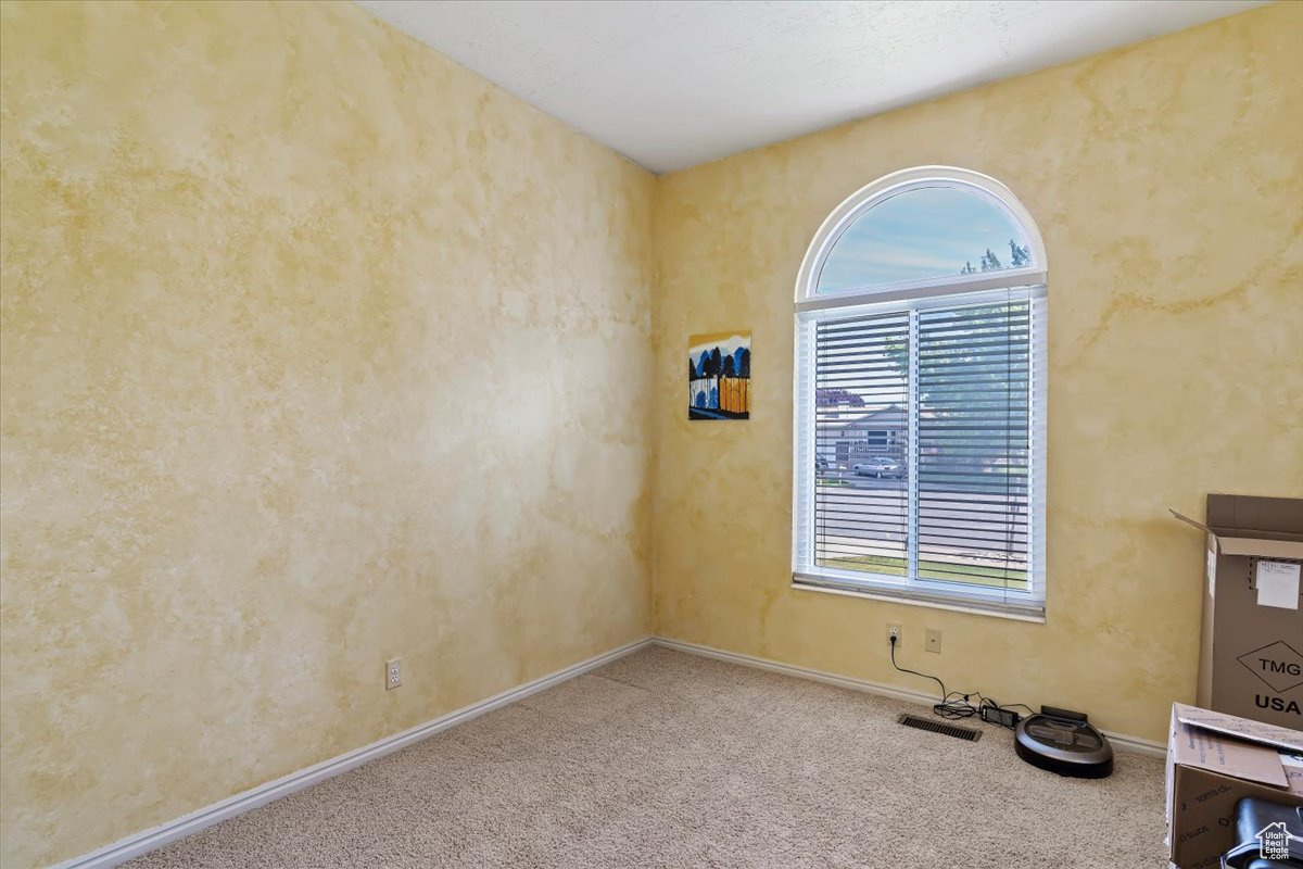 Spare room featuring carpet flooring