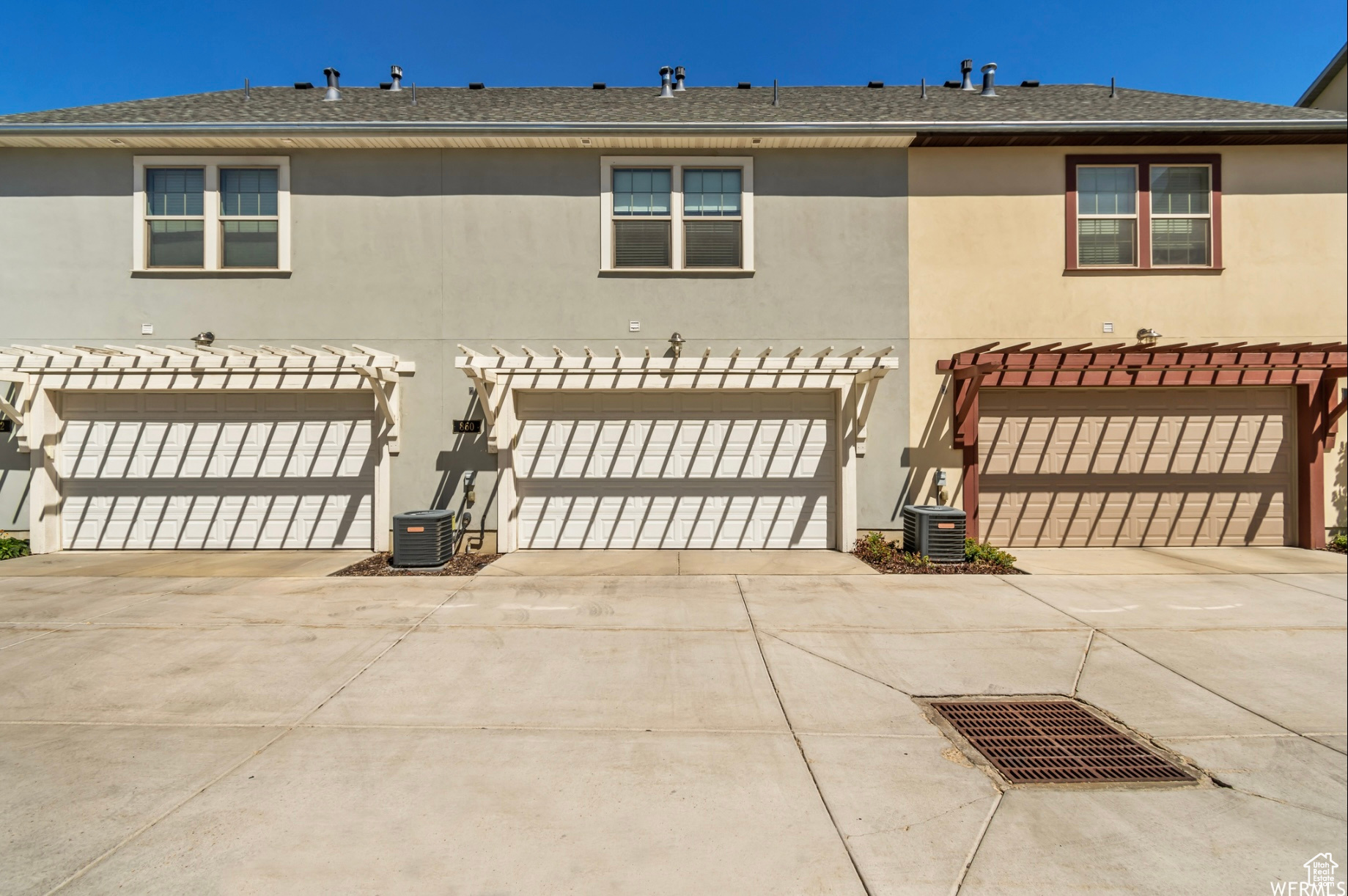 View of front facade with a garage and central AC