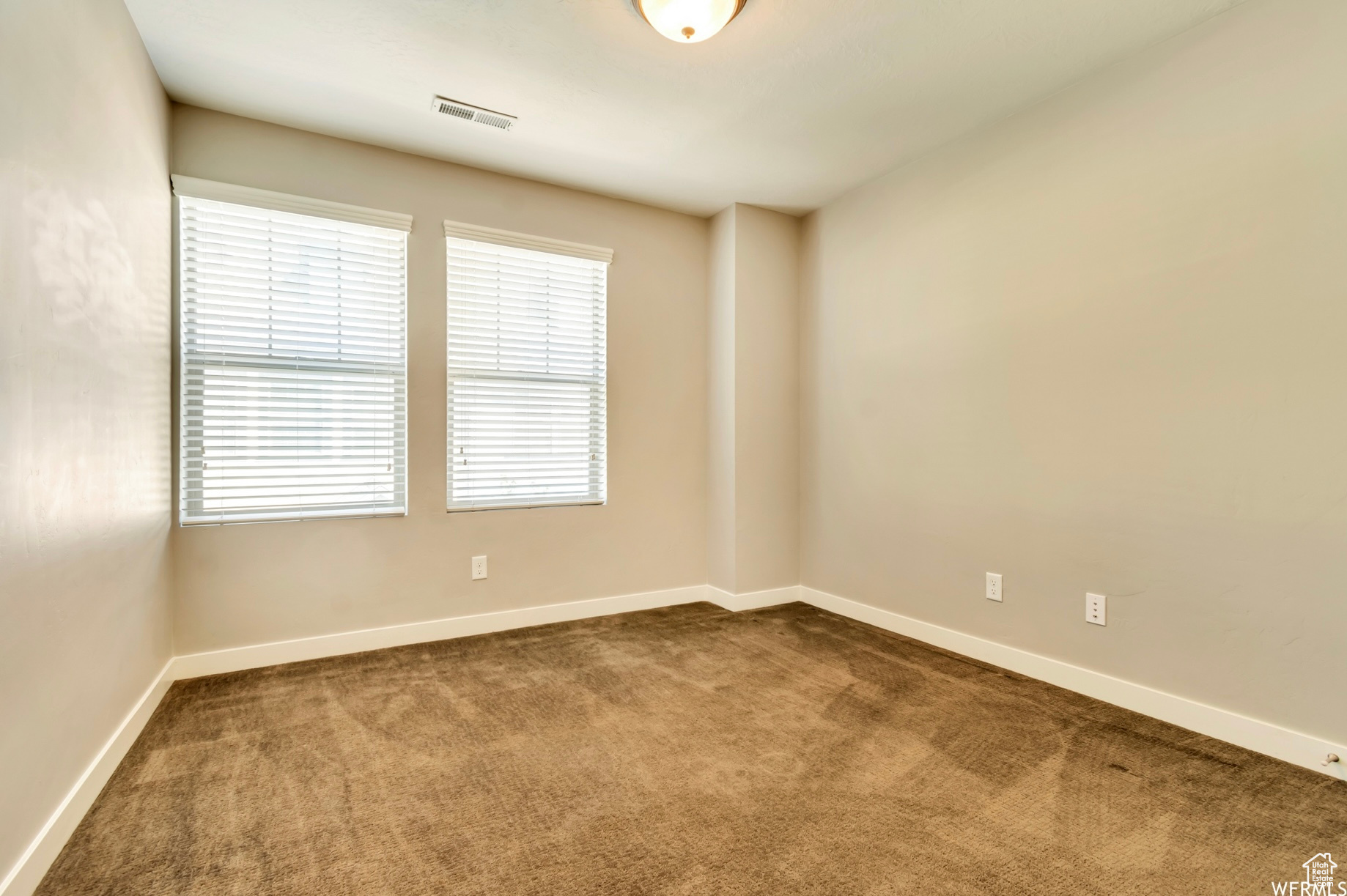 View of carpeted spare room