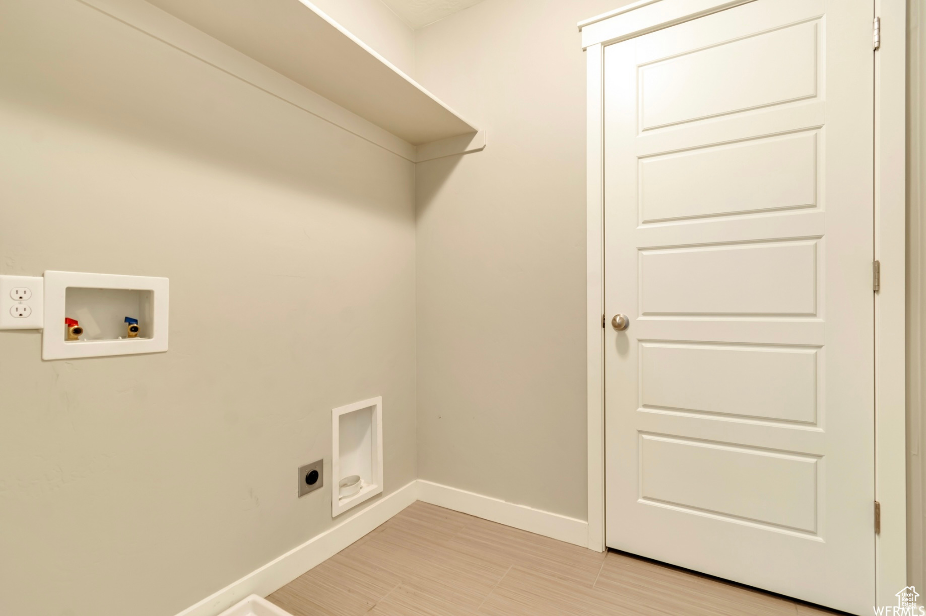 Laundry room with washer hookup, hookup for an electric dryer, and light tile floors