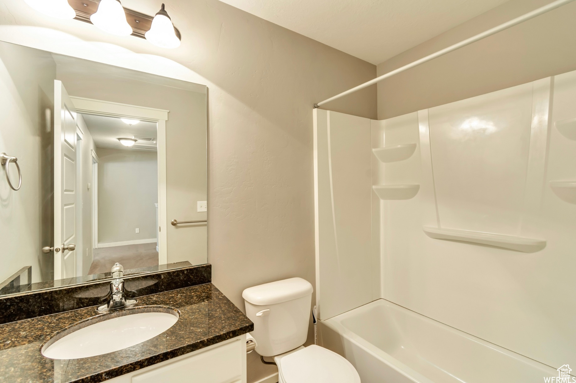 Full bathroom featuring shower / bathing tub combination, toilet, and vanity