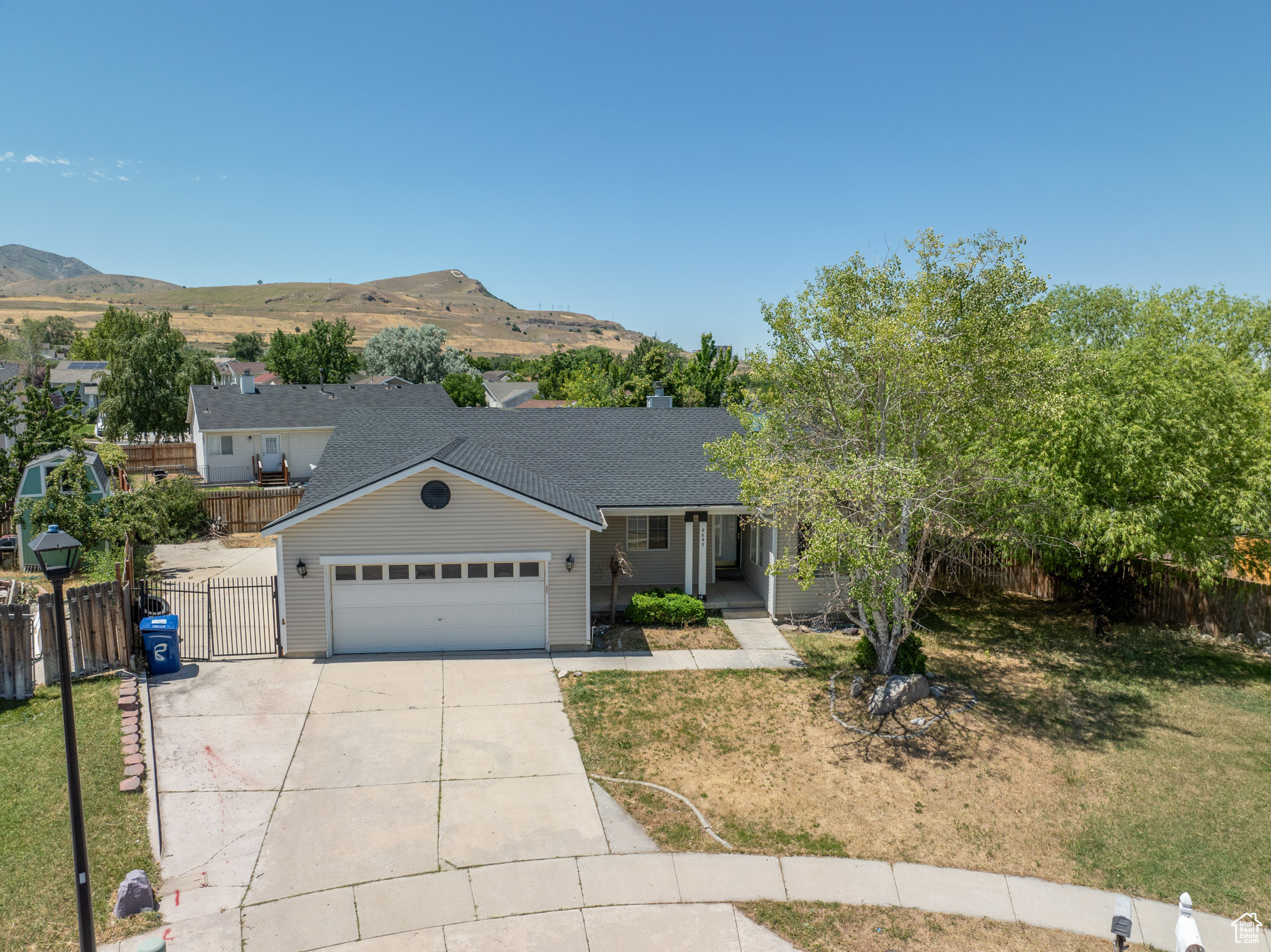 View of front of house featuring a large secured RV pad and mountain views.