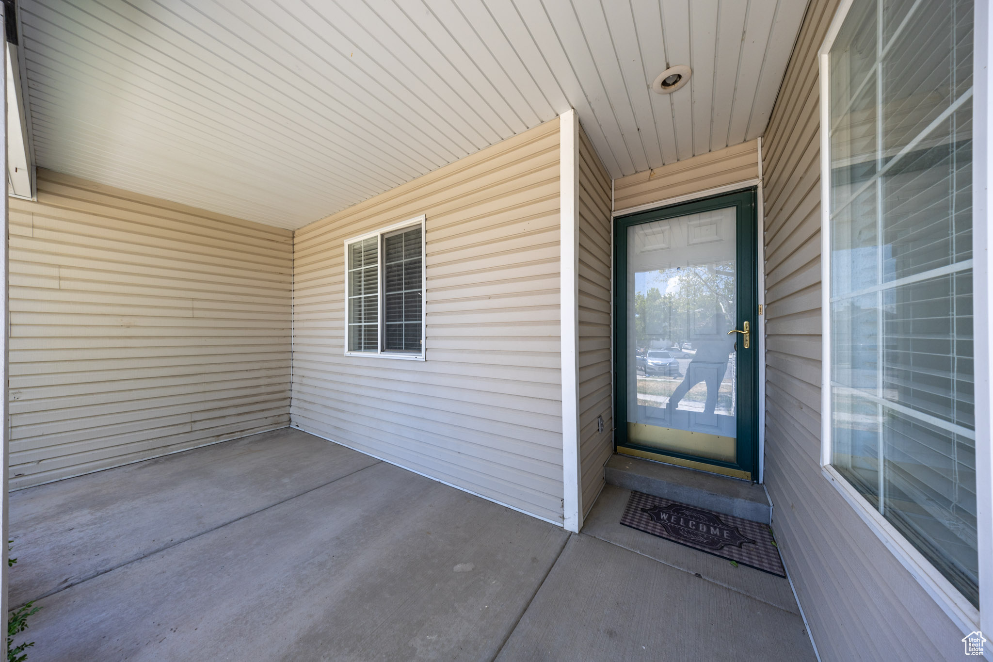 View of doorway to property featuring a covered front porch.