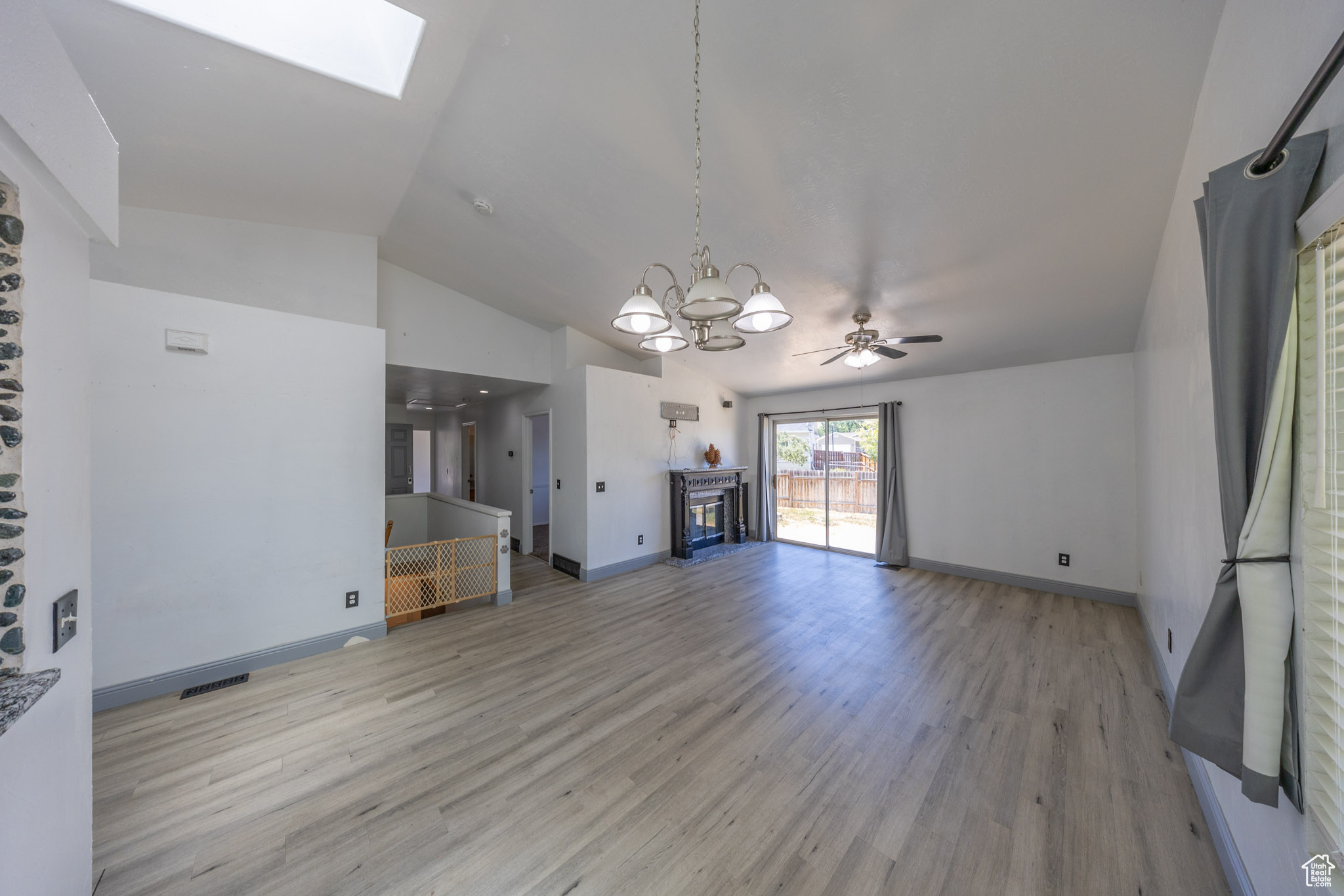 View of living room from the kitchen. Gas fireplace and sliding doors open up to a patio in the back yard.