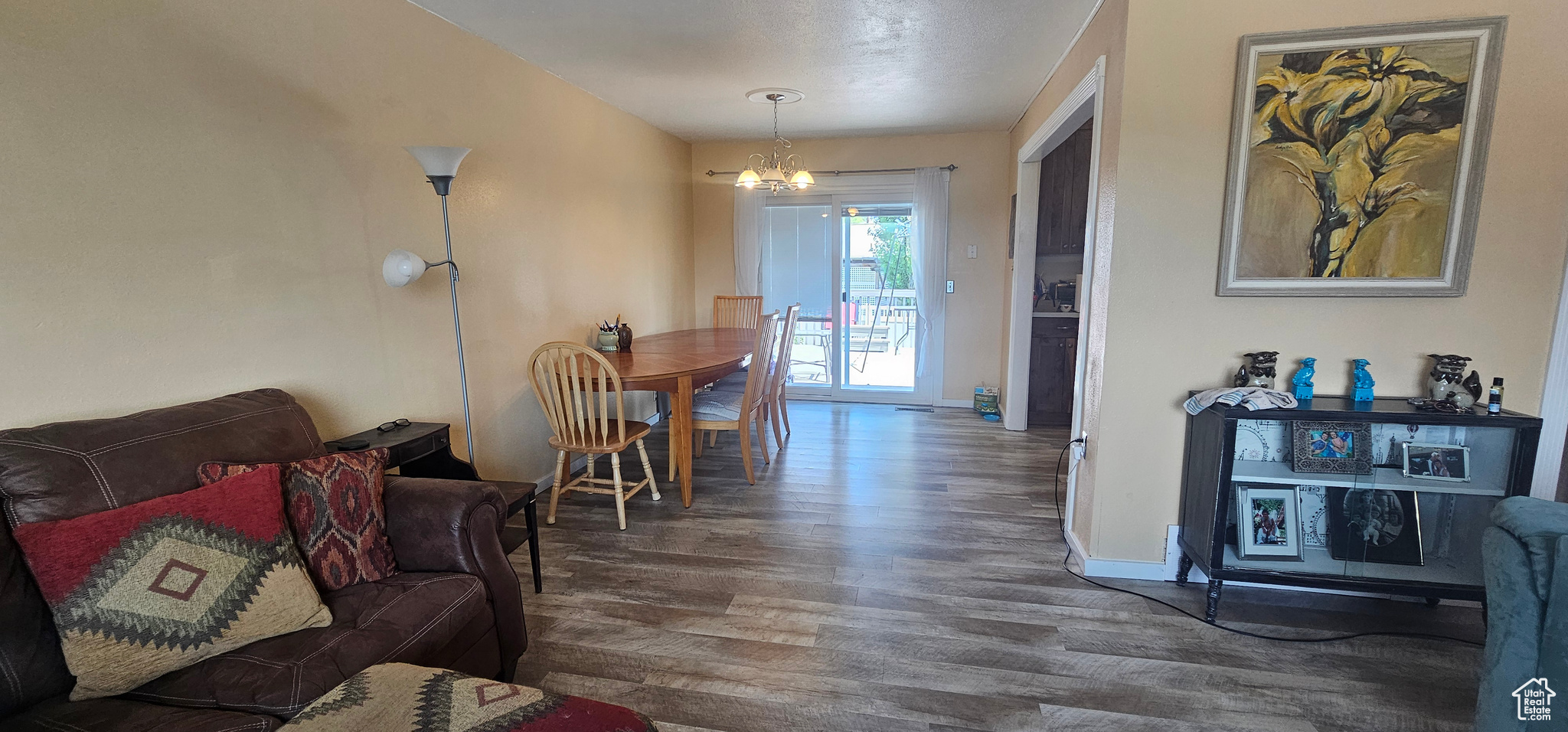 Living room featuring dark wood-type flooring and a notable chandelier