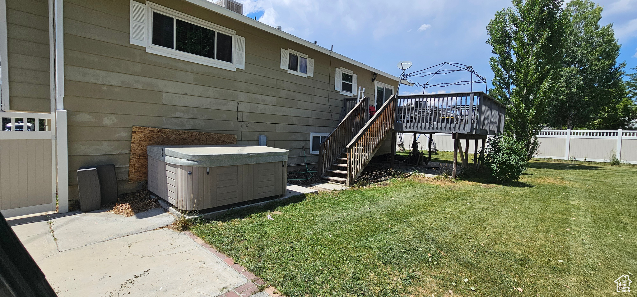 Exterior space featuring a wooden deck and a yard