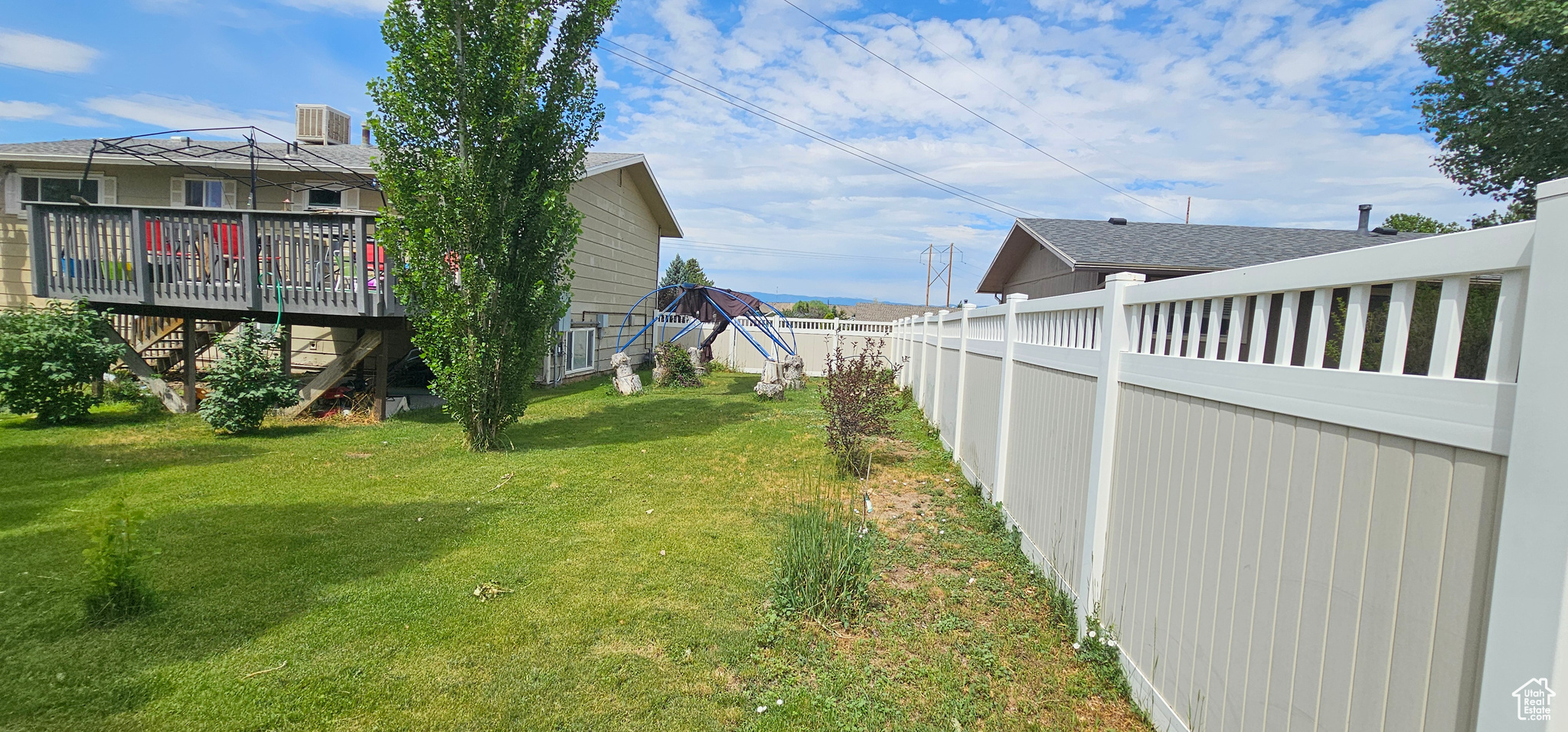 View of yard featuring a wooden deck