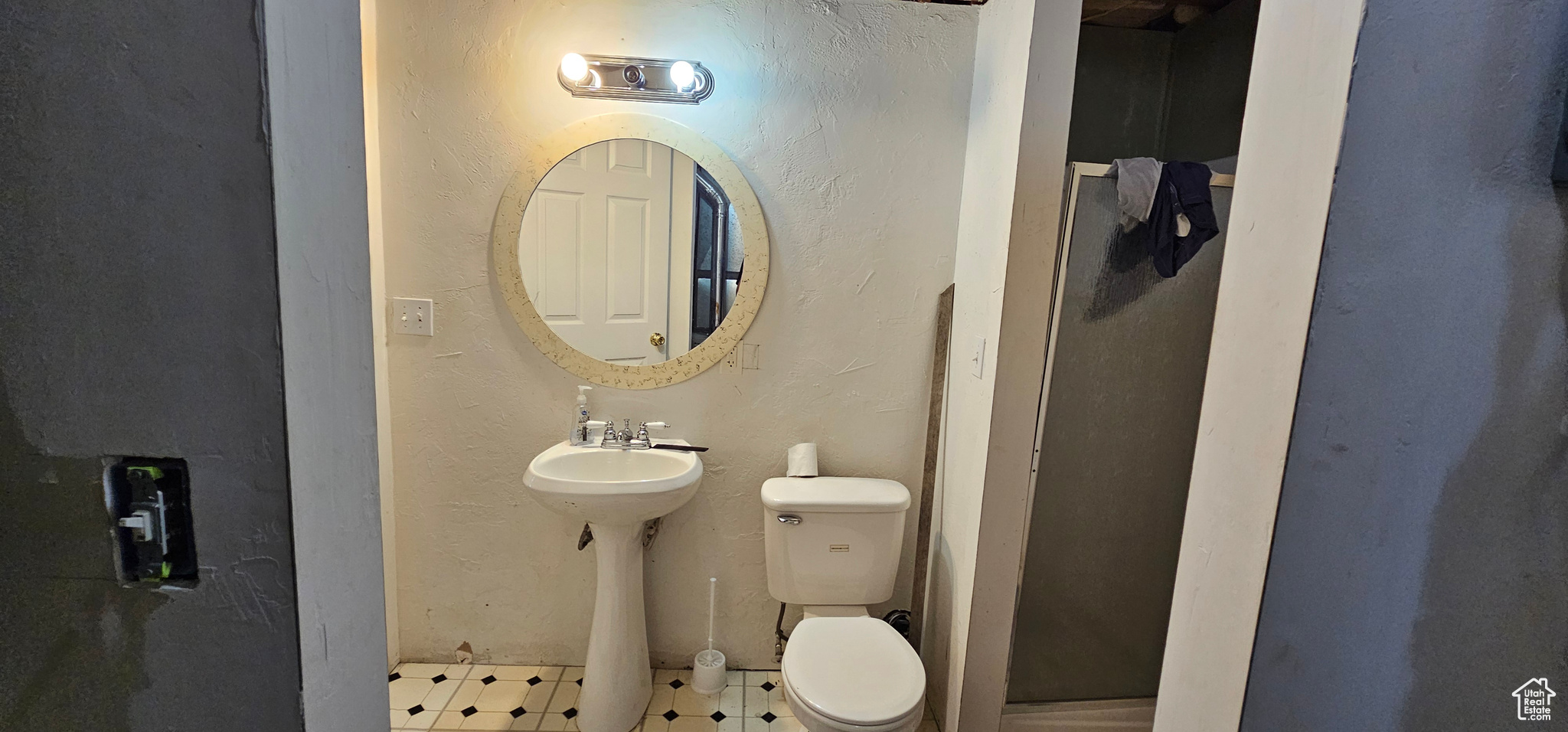 Bathroom with tile flooring, walk in shower, and toilet