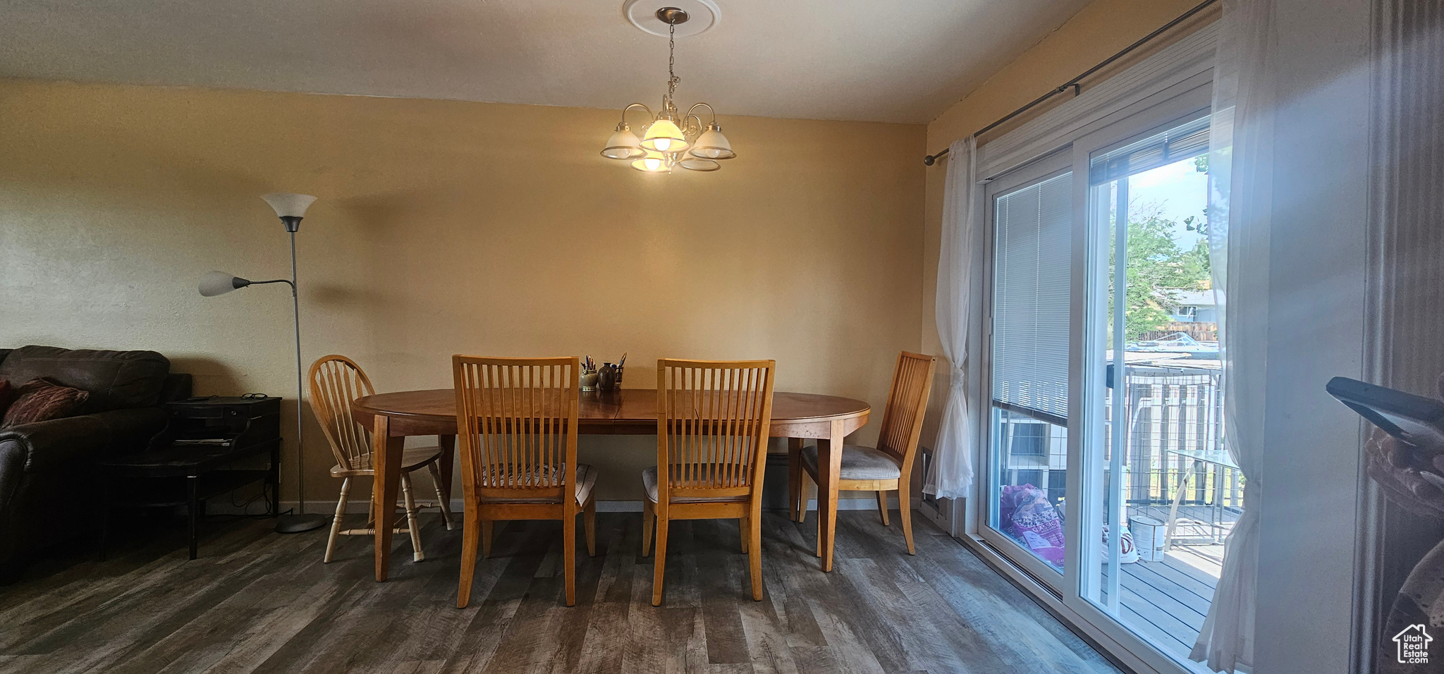 Dining room with an inviting chandelier and dark hardwood / wood-style floors