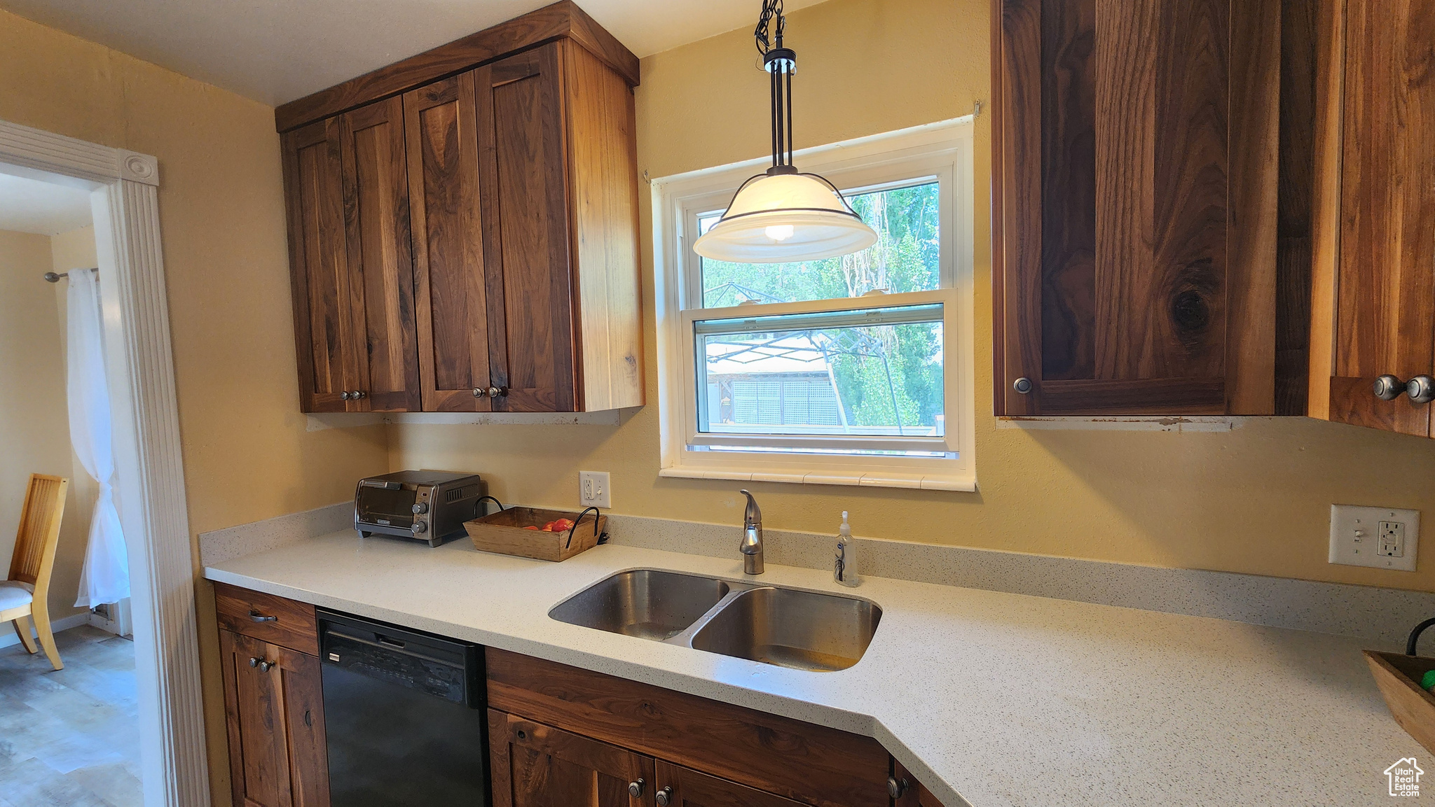 Kitchen with sink, dishwasher, and pendant lighting