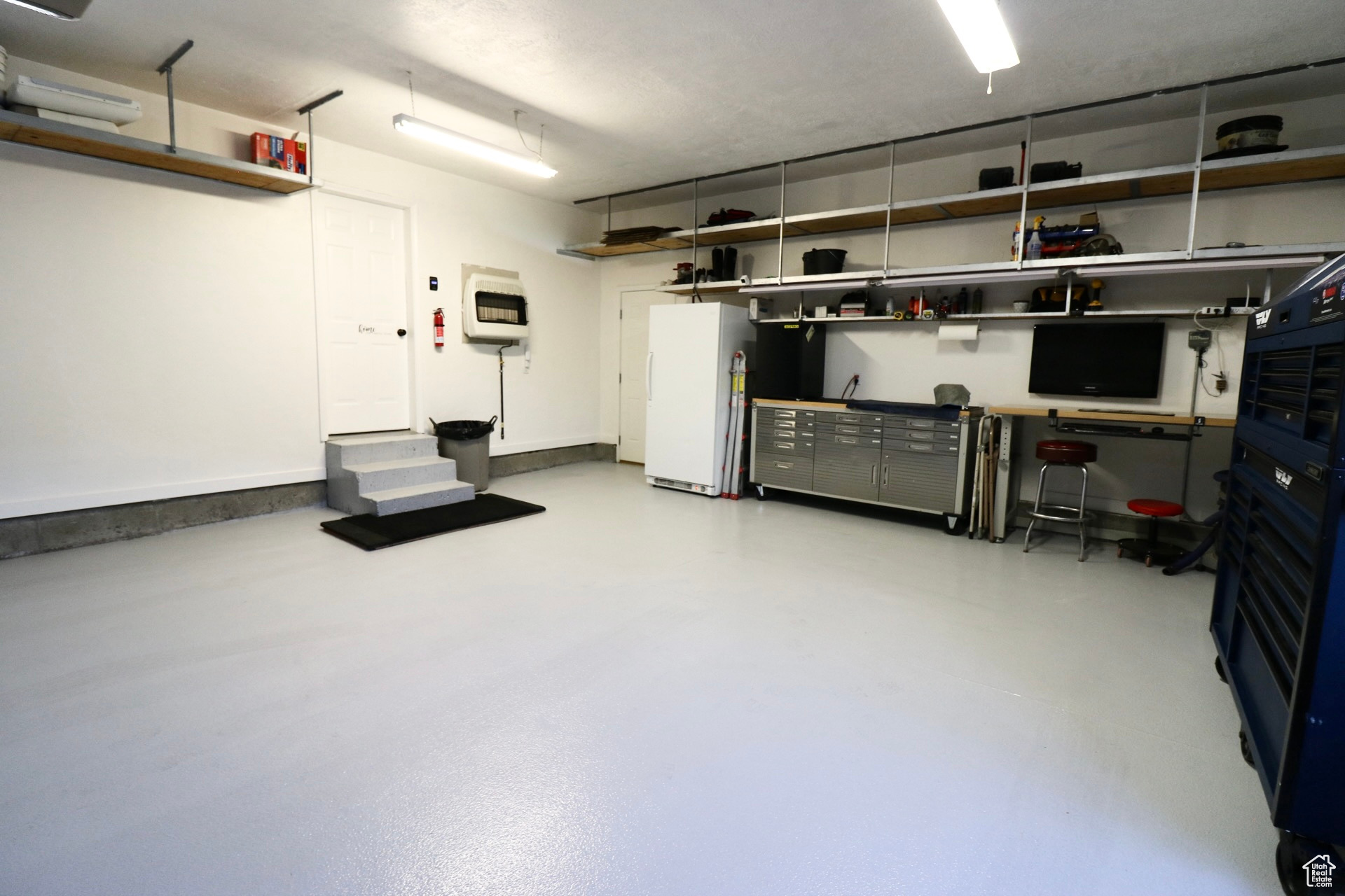 Garage with white fridge