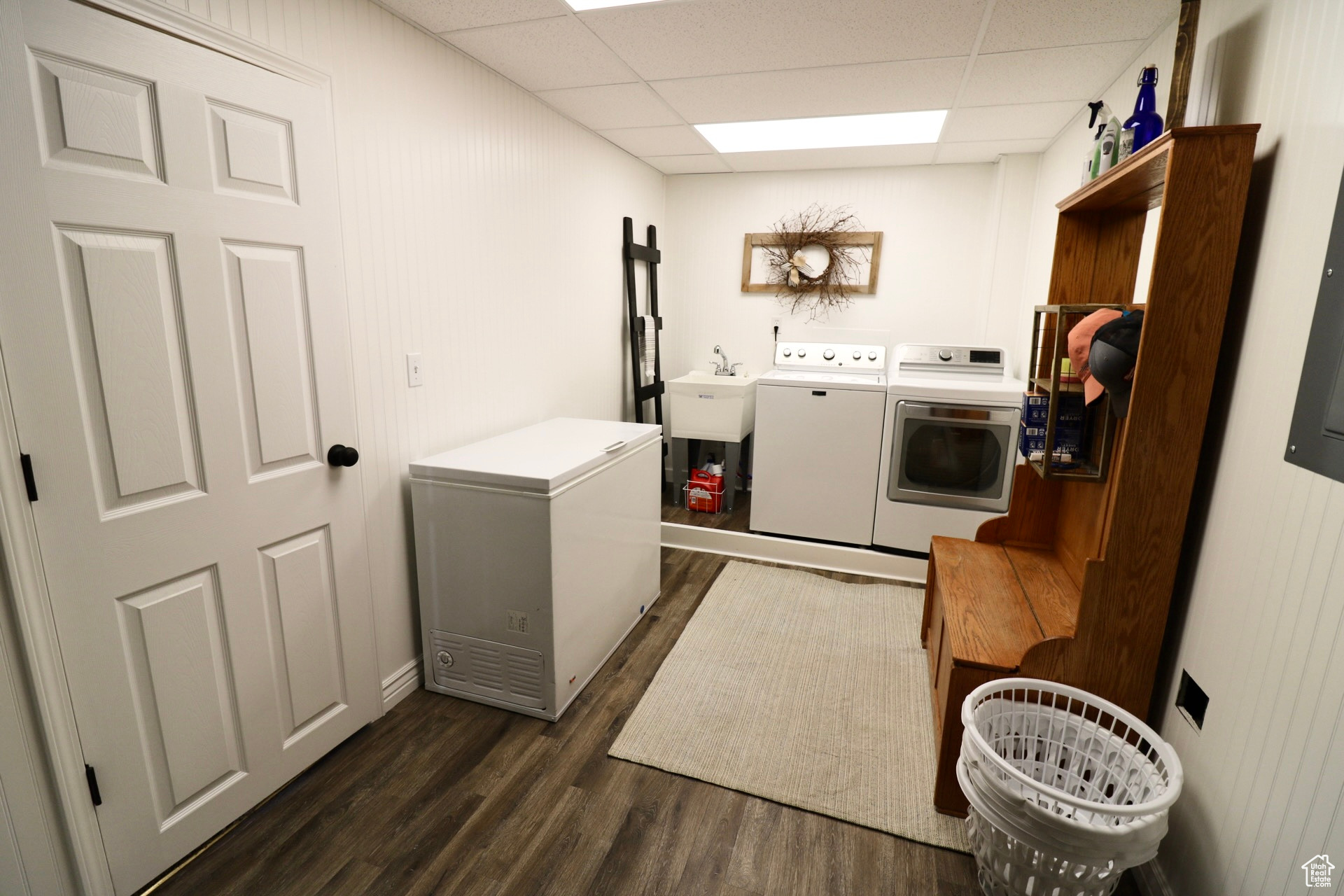 Washroom featuring sink, dark hardwood / wood-style floors, and washing machine and clothes dryer