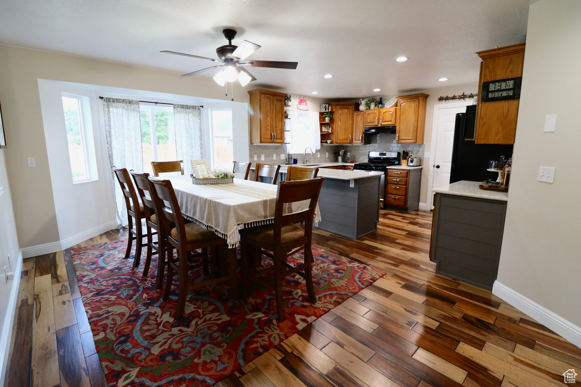 Dining area featuring sink, dark wood-type flooring, and ceiling fan