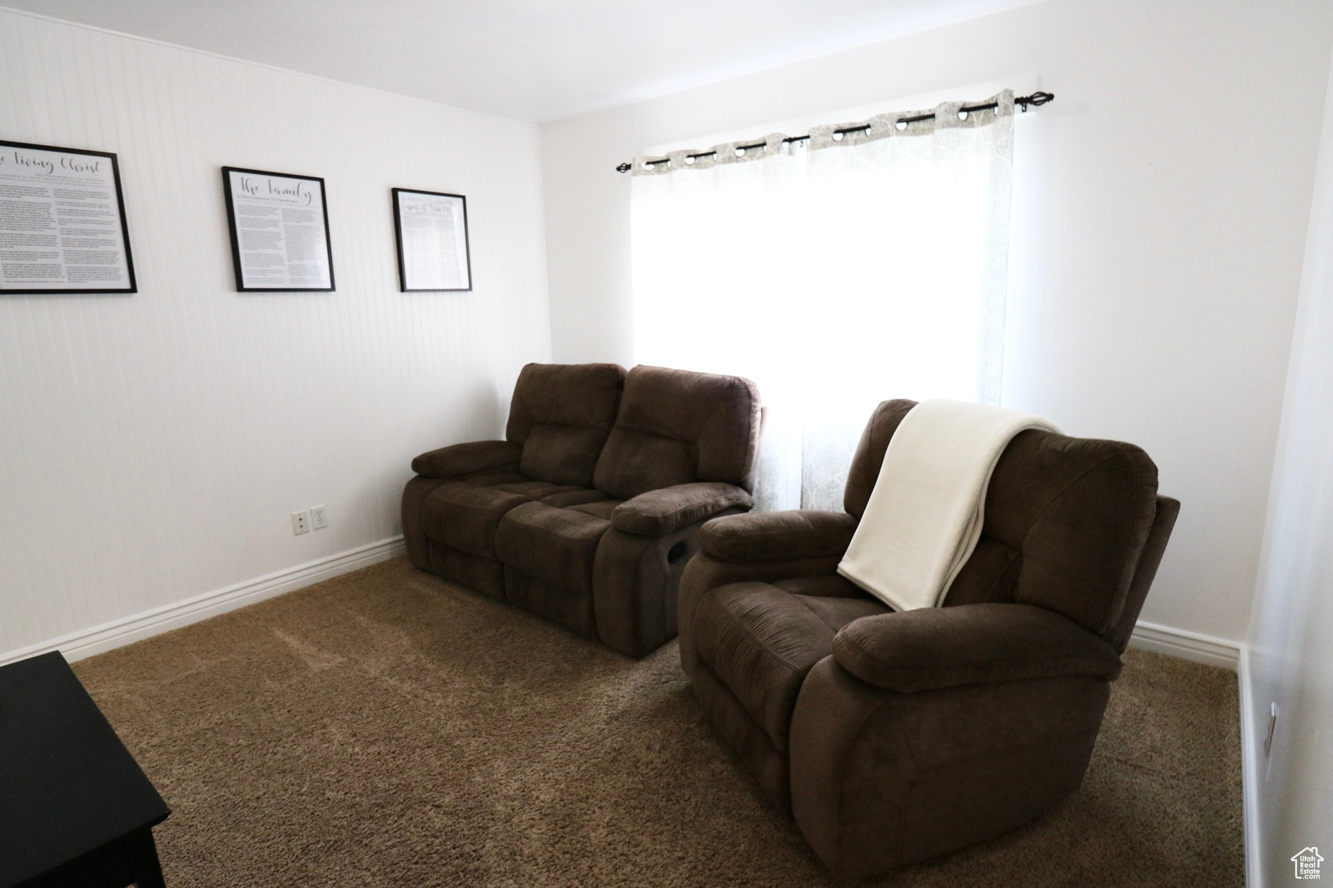 Living area featuring dark colored carpet