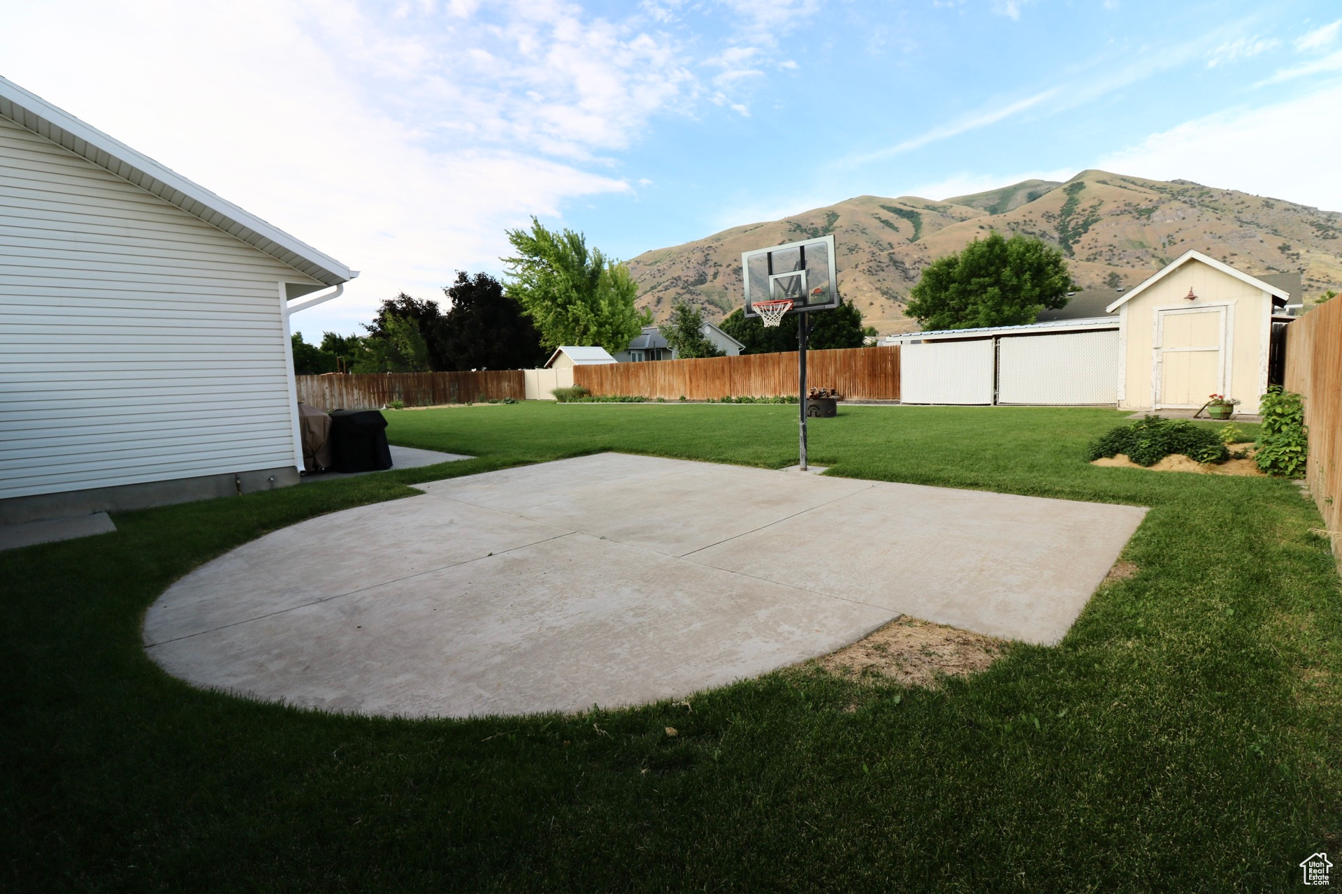 View of yard featuring a patio, a storage shed, and a mountain view