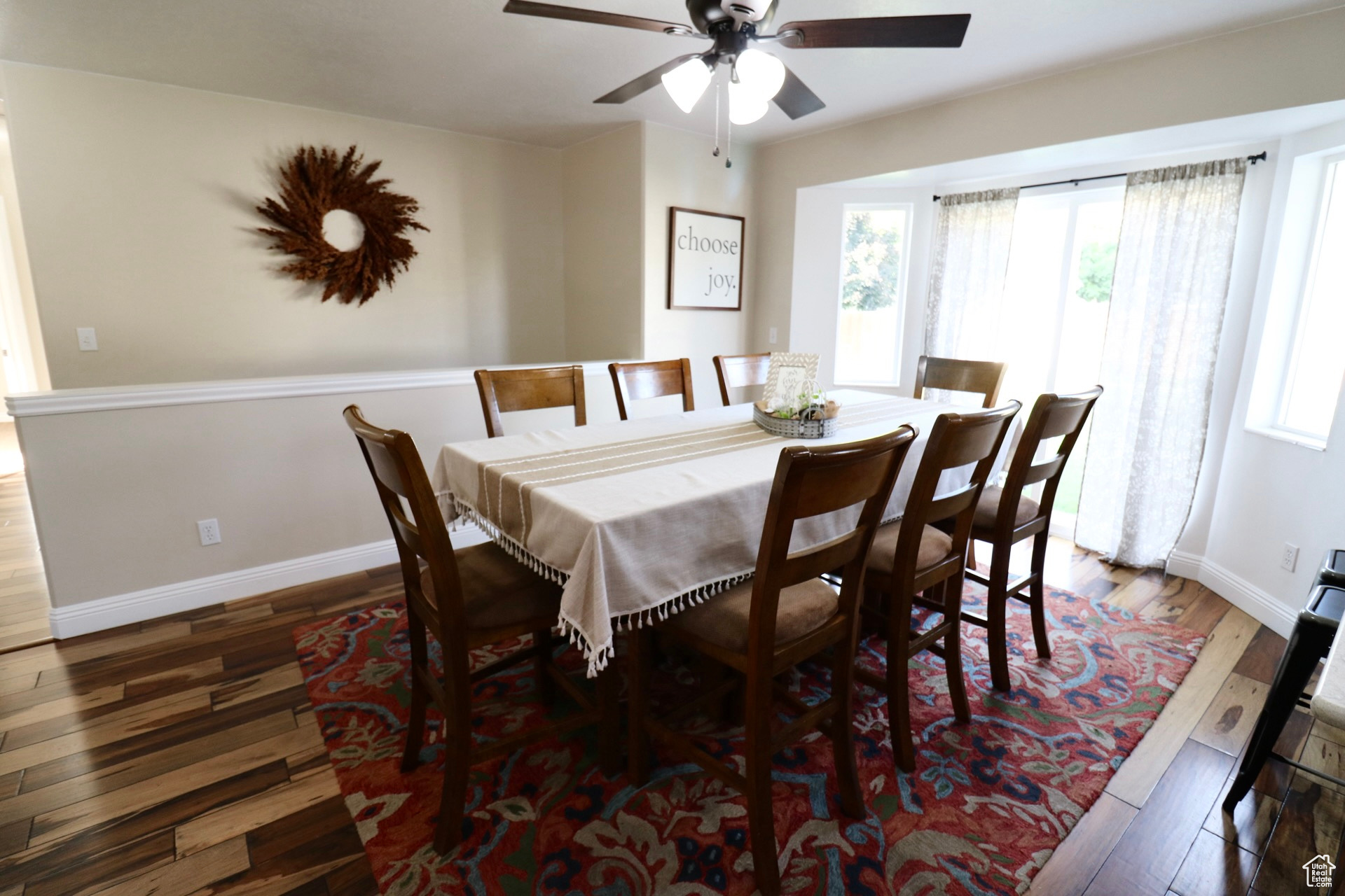 Dining room with wood-type flooring and ceiling fan