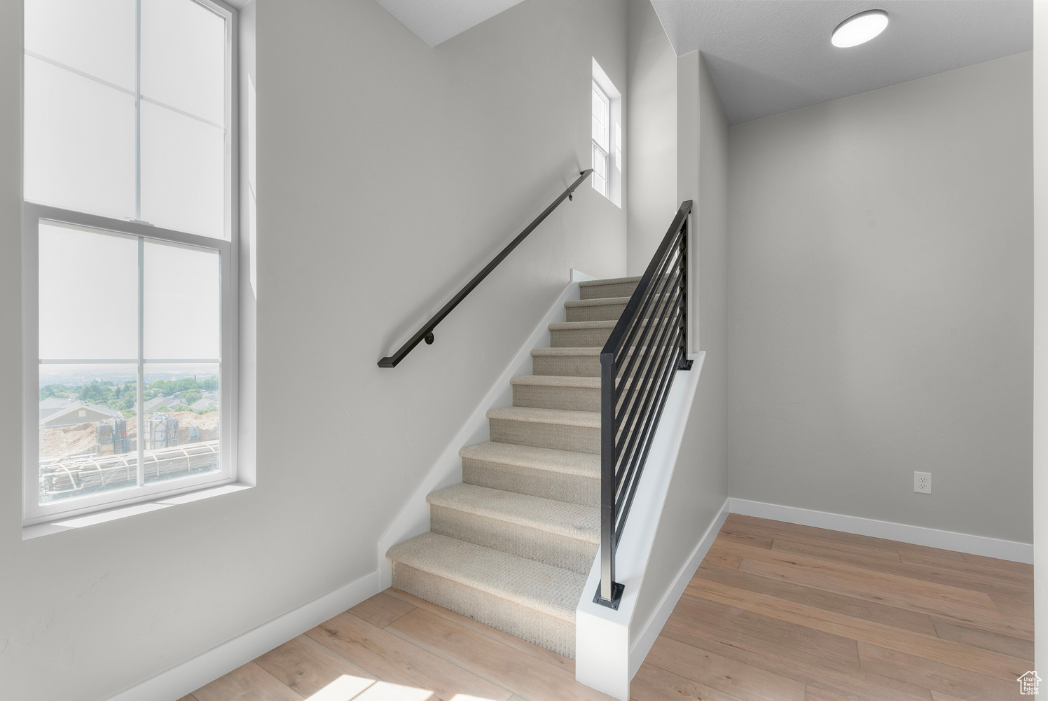 Stairs featuring light hardwood / wood-style flooring