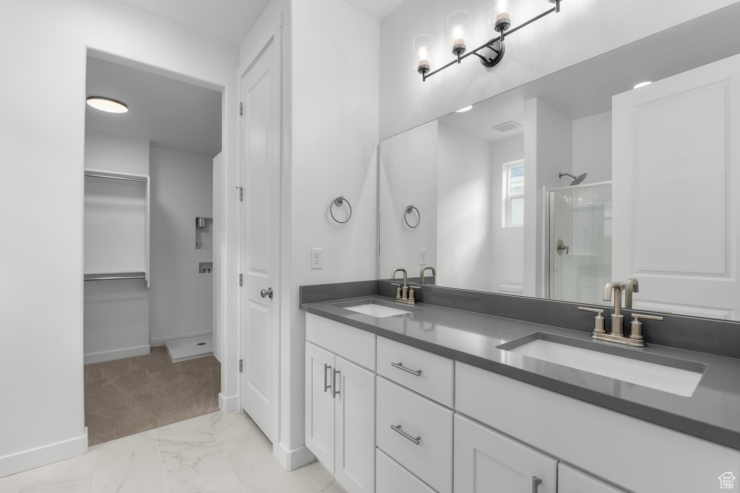 Bathroom featuring vanity and a shower with shower door