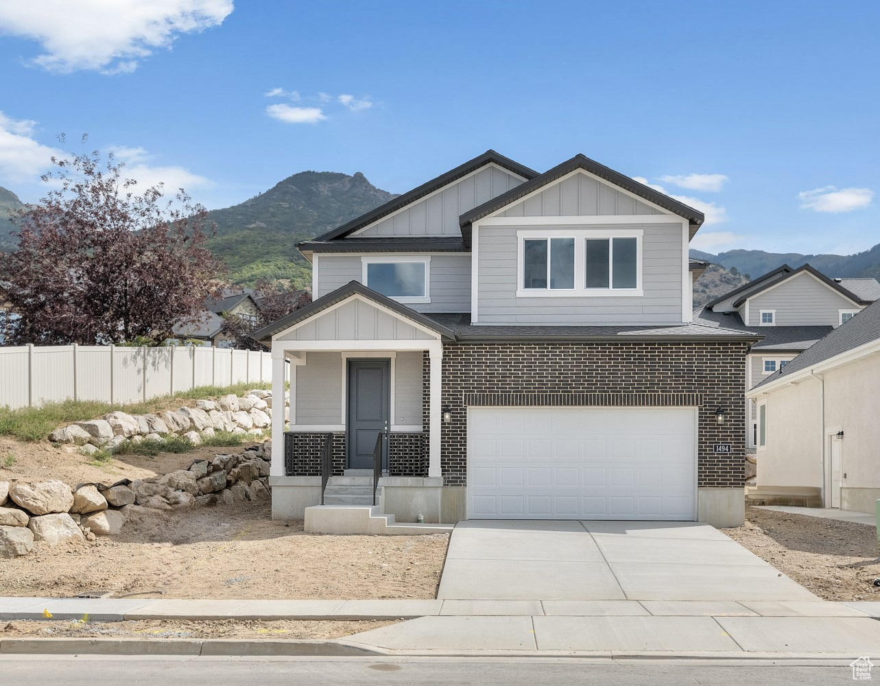 View of front facade with a garage and a mountain view