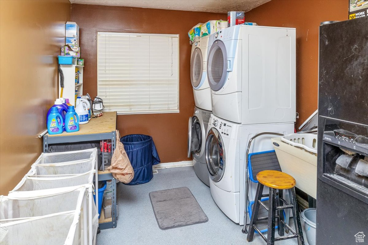 Laundry room featuring stacked washer / dryer