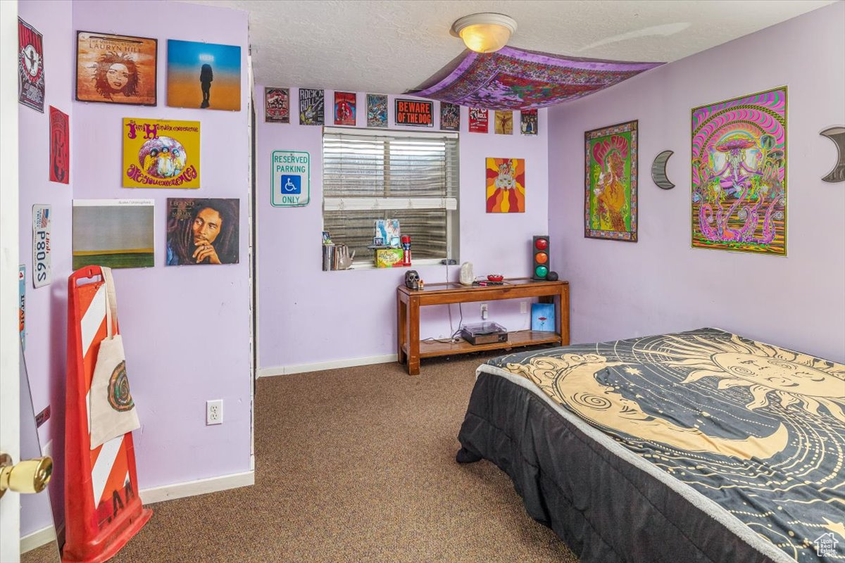 Bedroom 5 with carpet and a textured ceiling