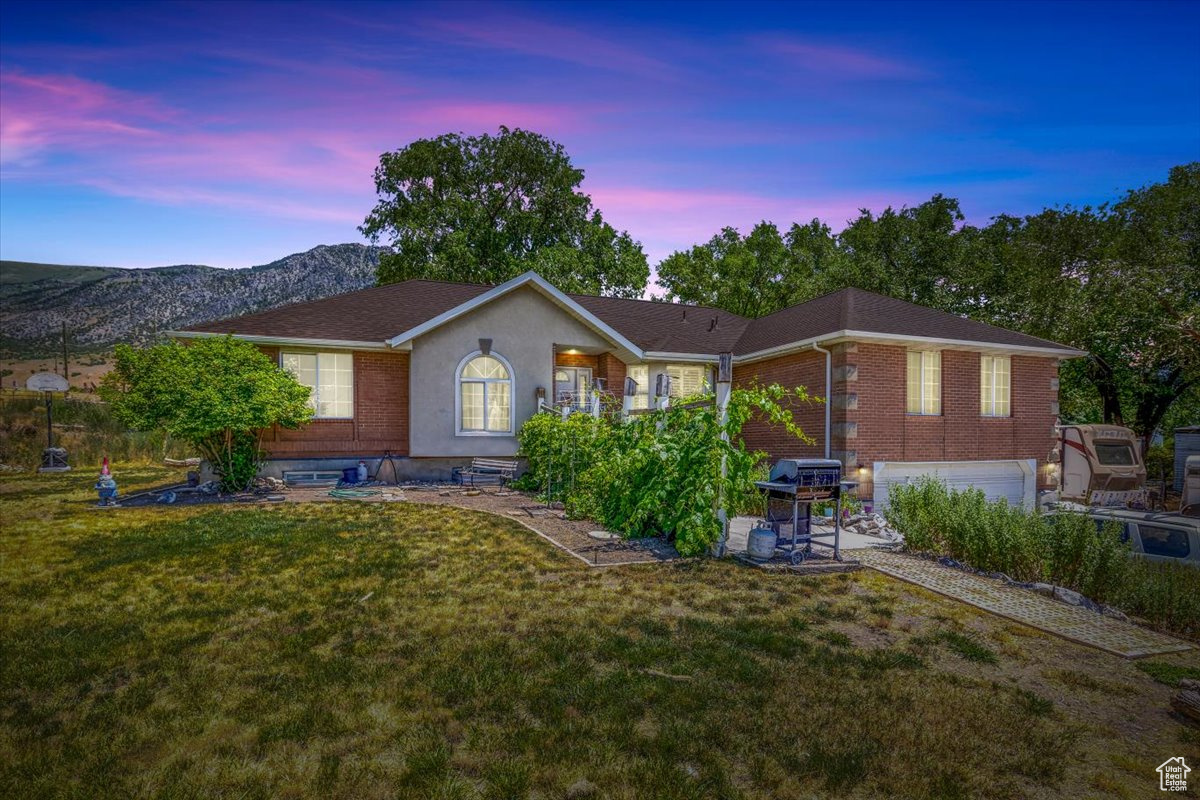 Ranch-style house with a patio, a garage, and a yard