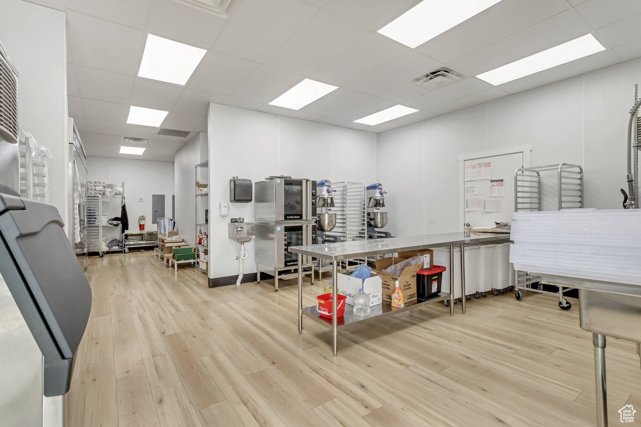 Interior space with light hardwood / wood-style flooring and a drop ceiling