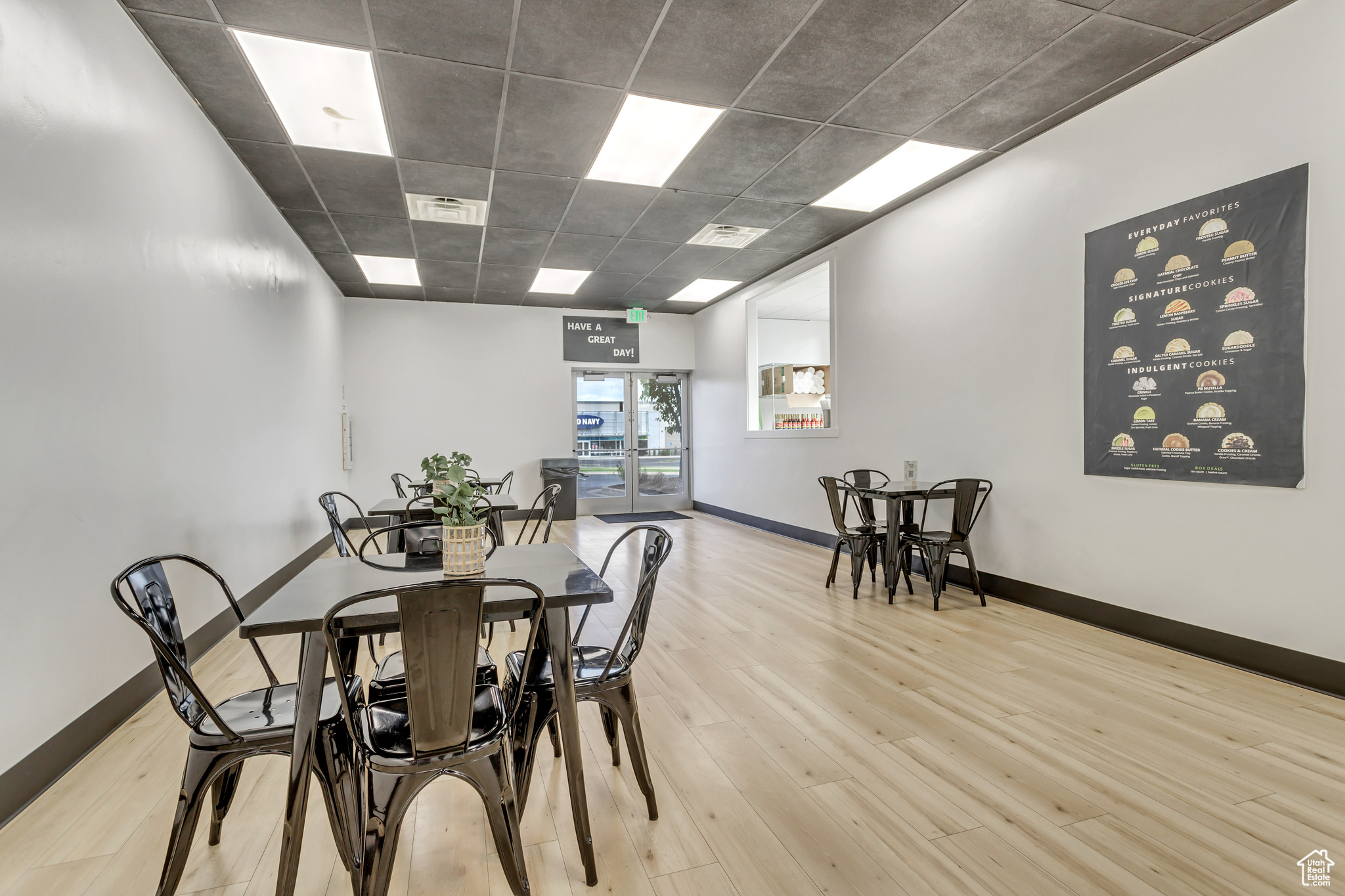 Dining area featuring light hardwood / wood-style flooring and a paneled ceiling