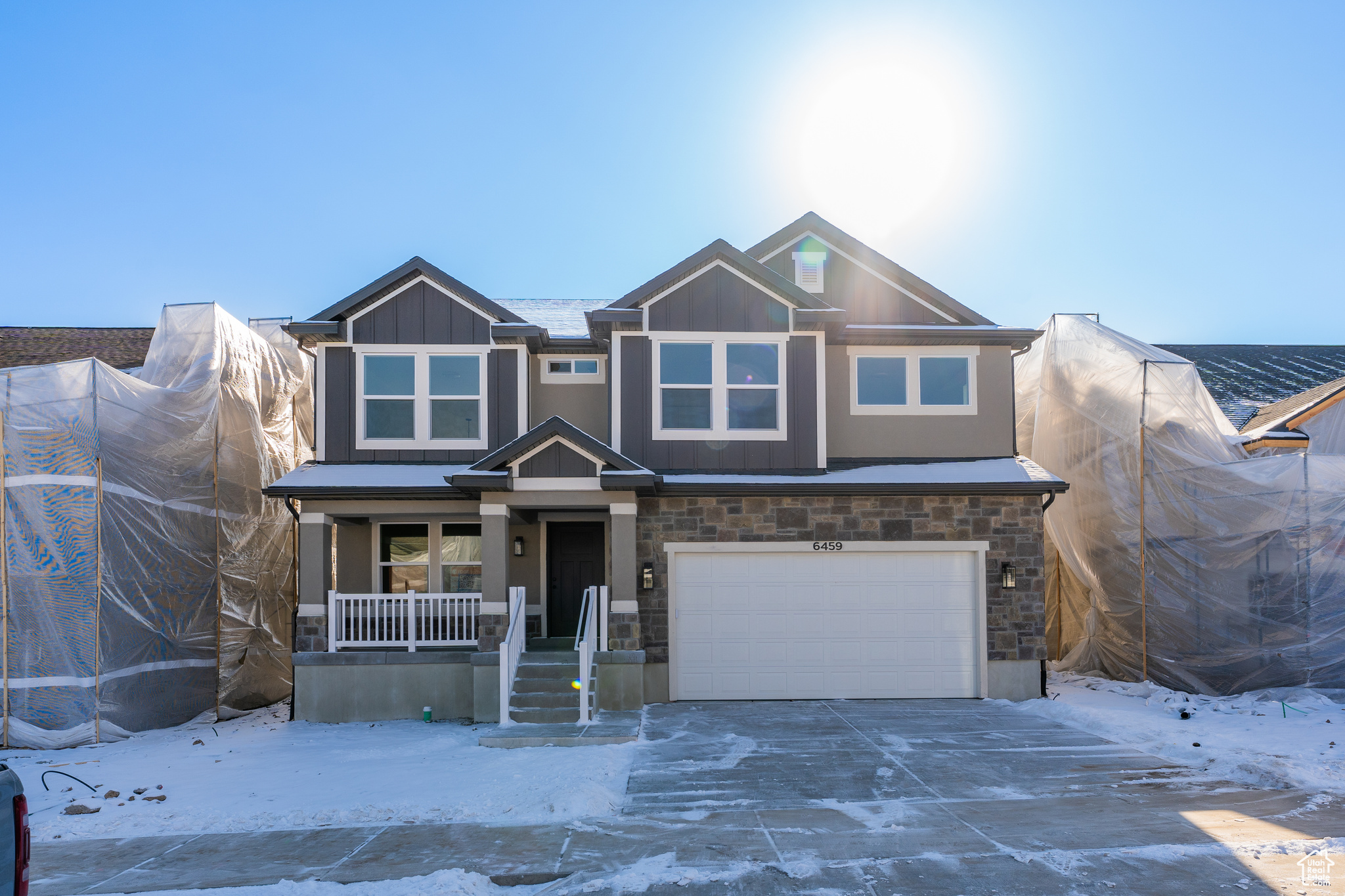 View of front of home featuring a garage and covered porch