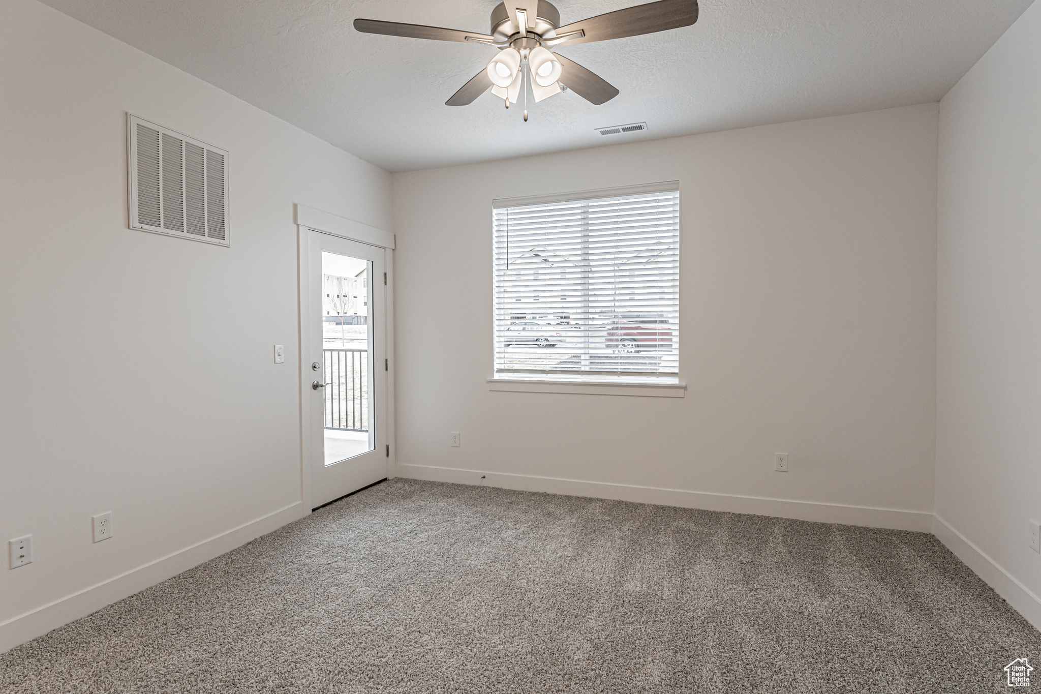 Spare room with ceiling fan and carpet floors