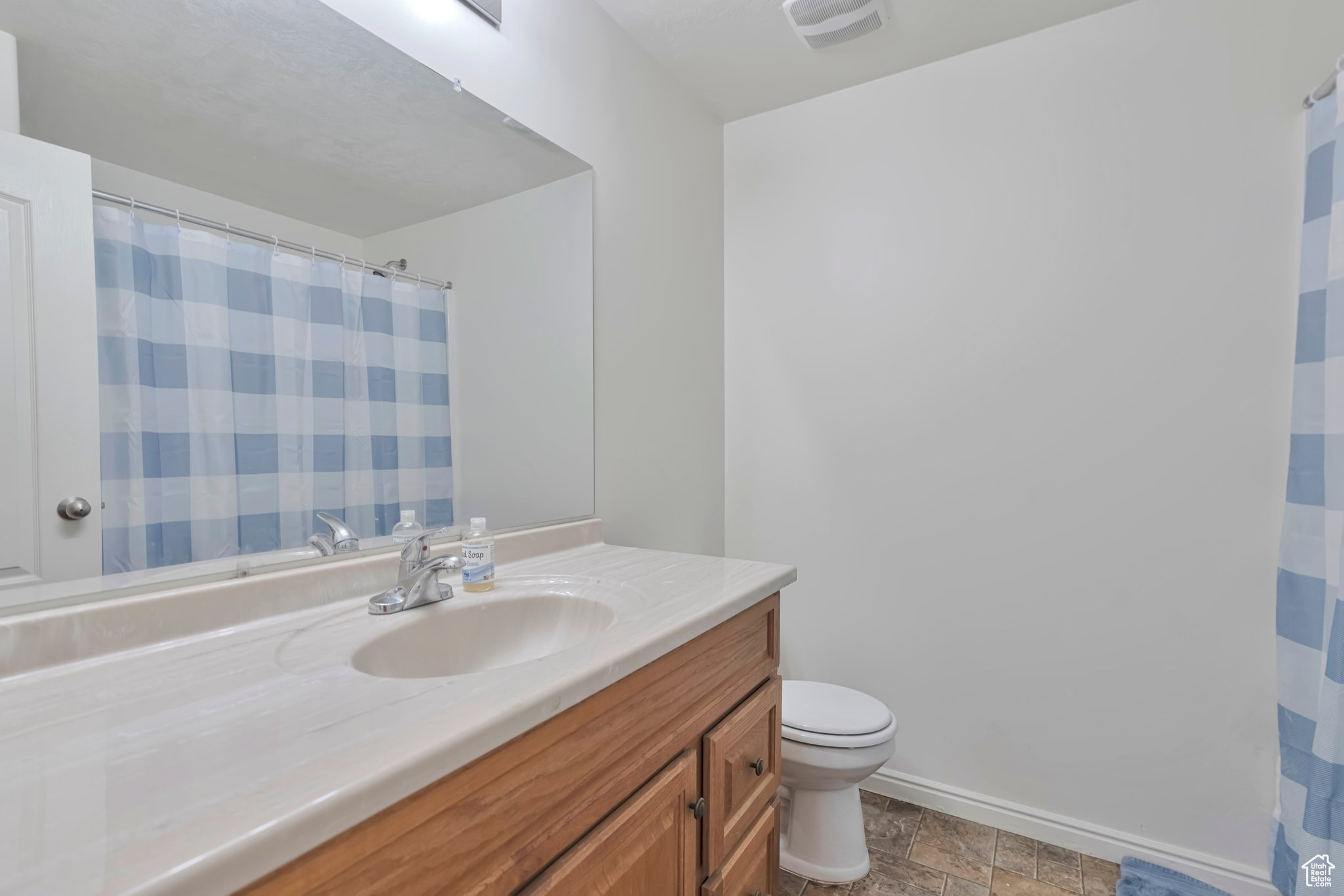 Bathroom with tile patterned floors, vanity, and toilet