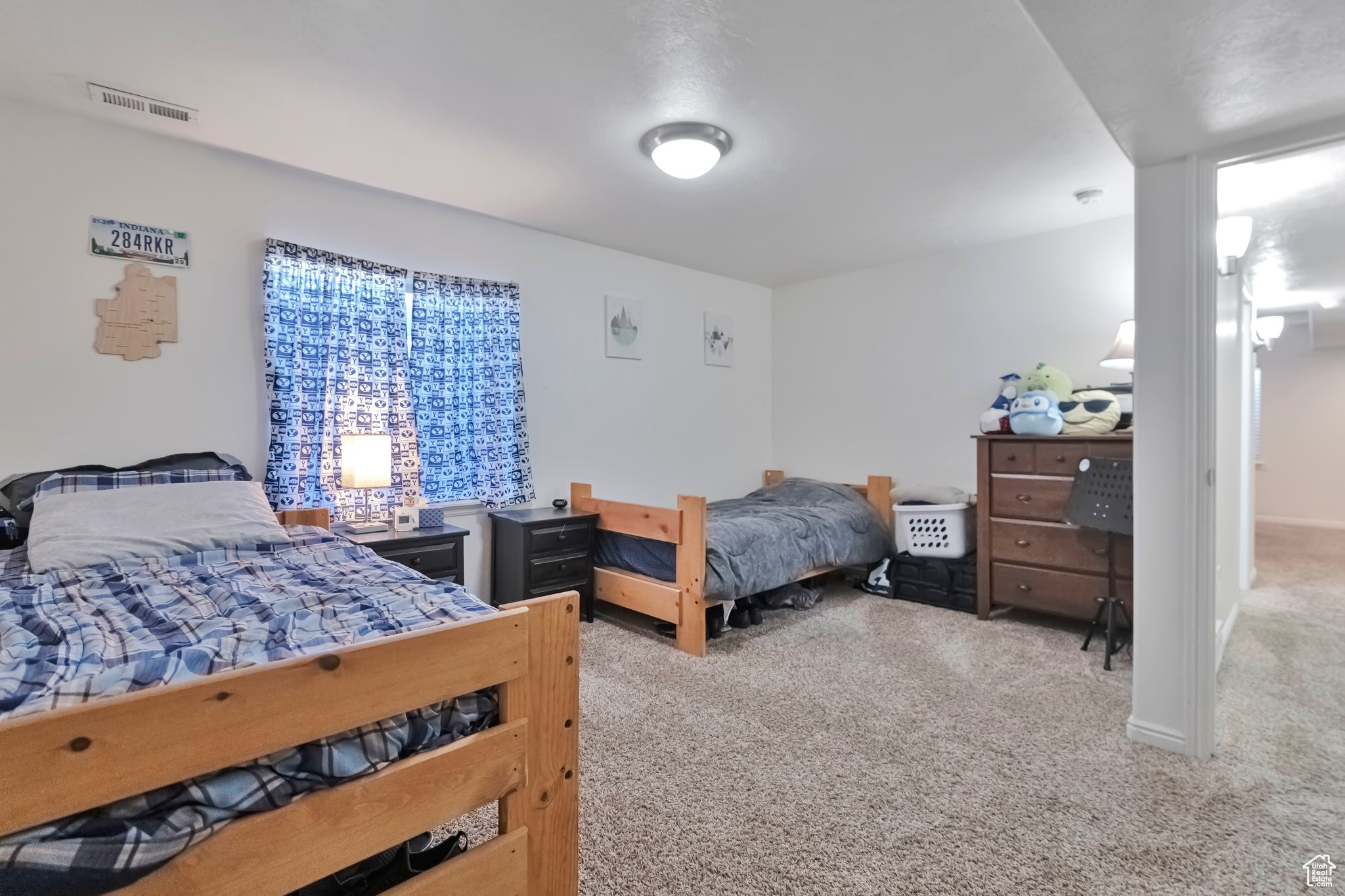 Bedroom featuring light carpet